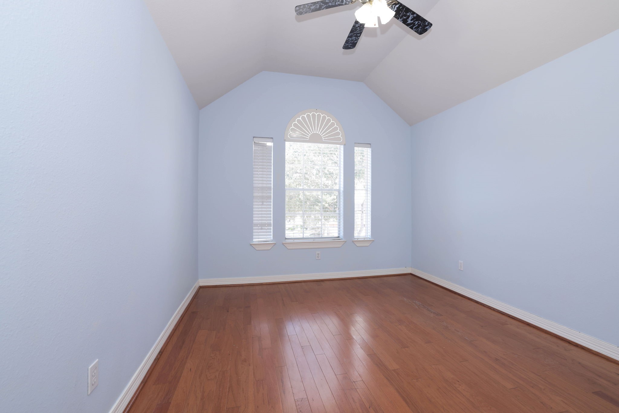 Bedroom 2 is upstairs and has soaring ceiling and hardwood floors that run throughout the second floor.