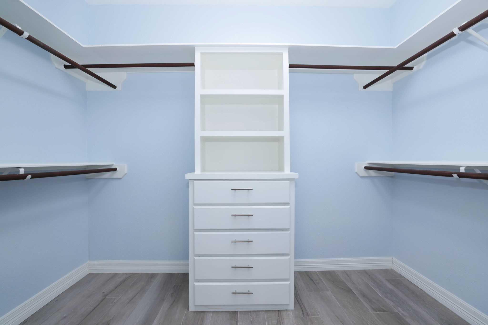 One of two primary closets with built ins and fresh paint.