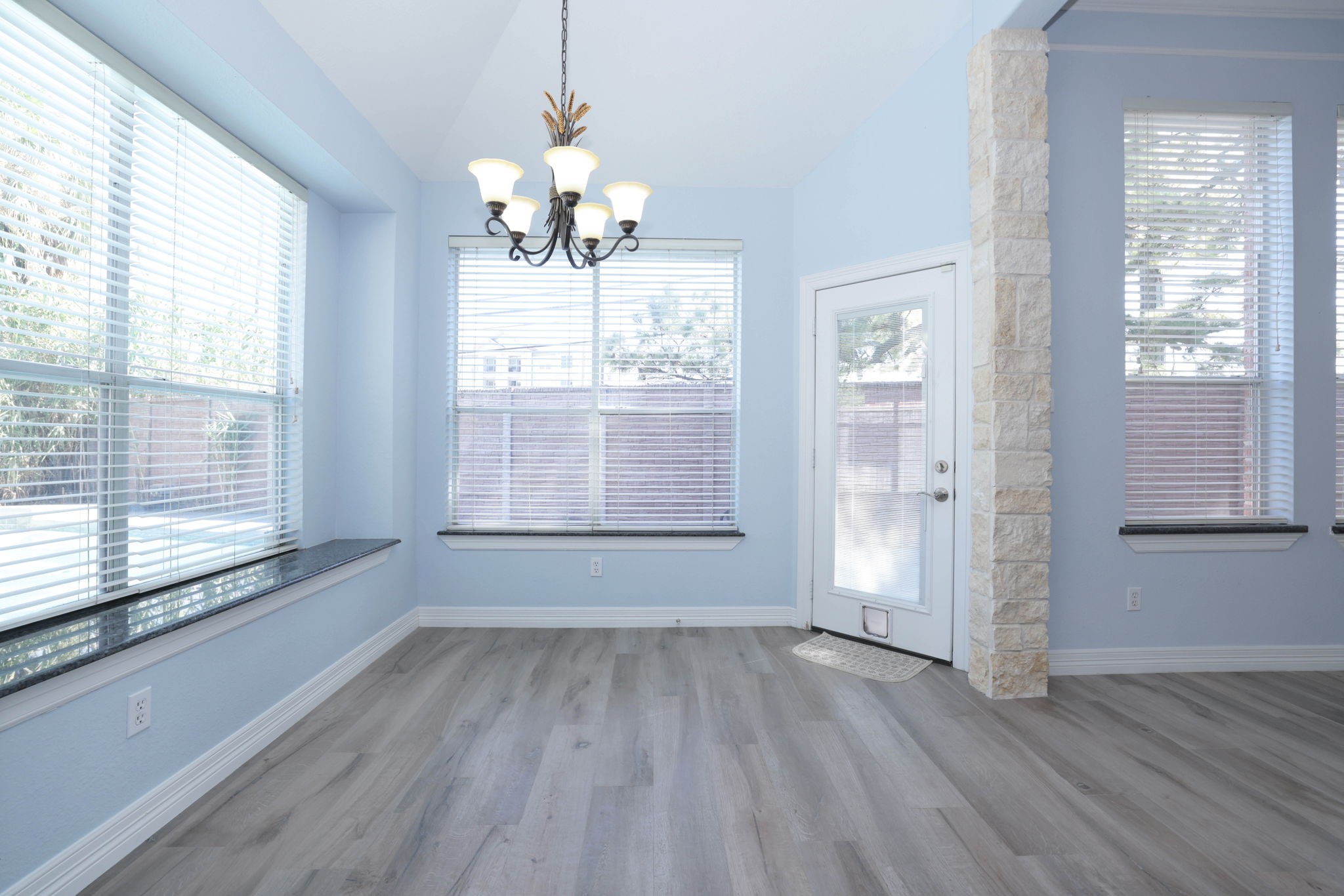 The breakfast room has a view of the pool and a door out to it.  There is a window seat with granite.  All window window sills are granite.