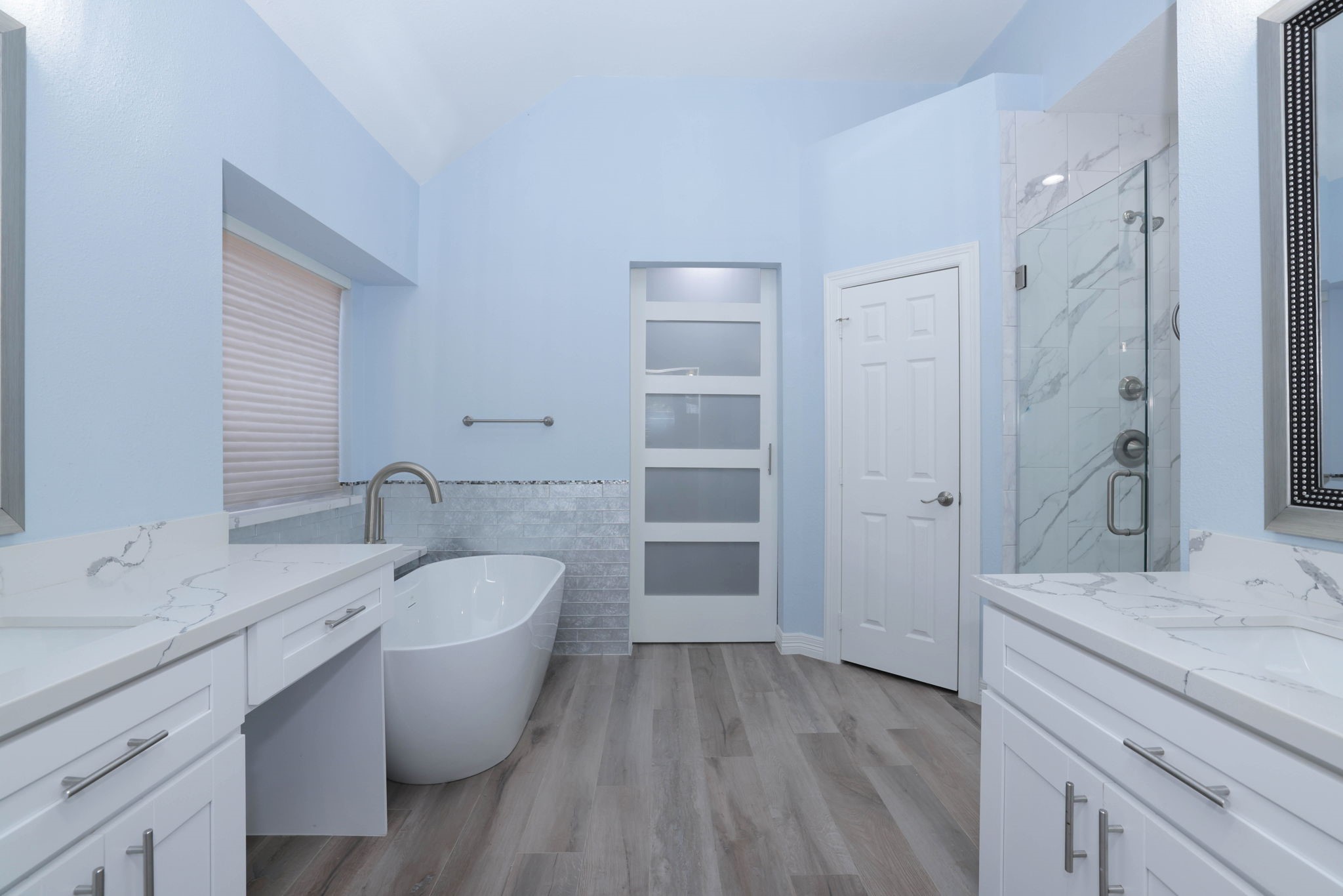 Totally new primary bath with soft close cabinets, quartz counters, designer tile, double sinks, large shower, and free standing soaking tub.