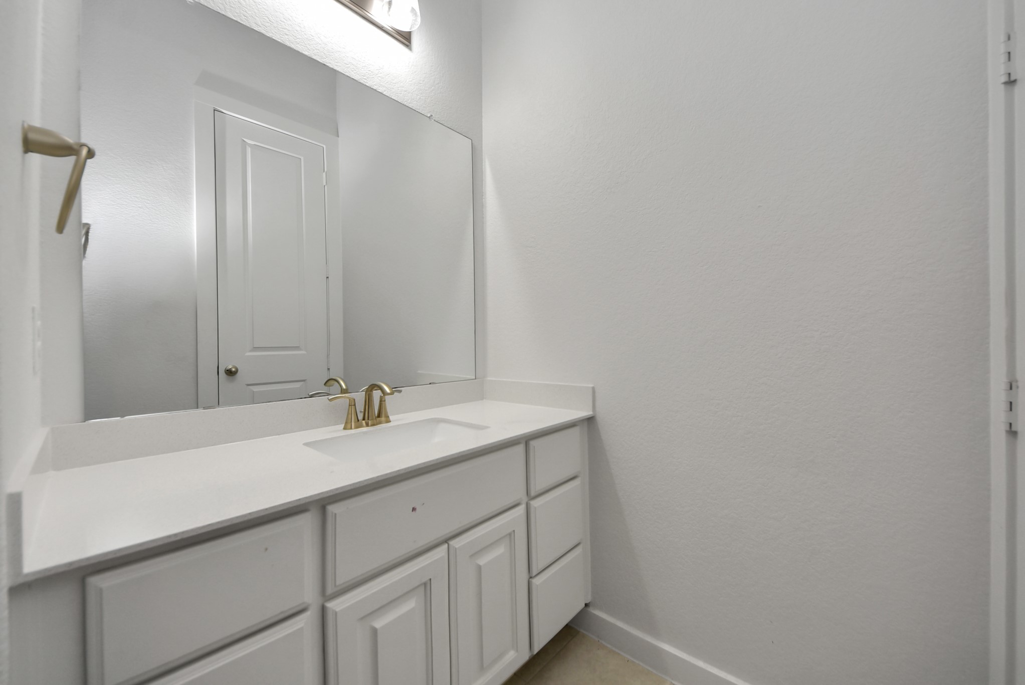 Beautiful bathroom vanity with ample cabinetry and a large mirror.
