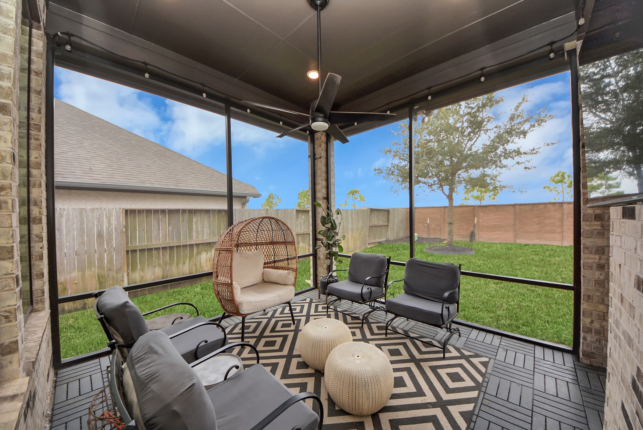 Inviting covered patio offering a comfortable space for outdoor relaxation and entertaining.