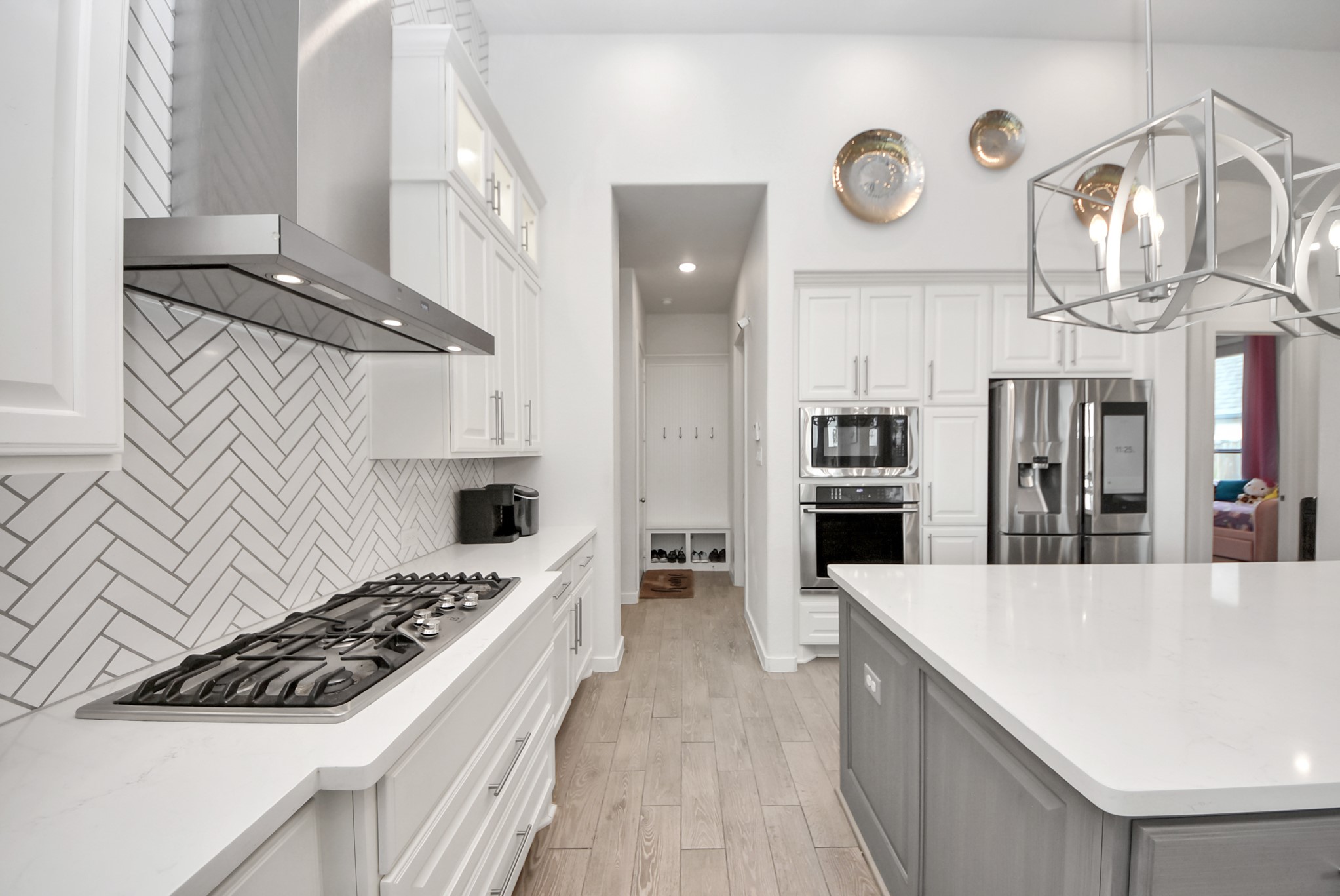 Modern kitchen with sleek countertops, stainless steel appliances, and elegant lighting.