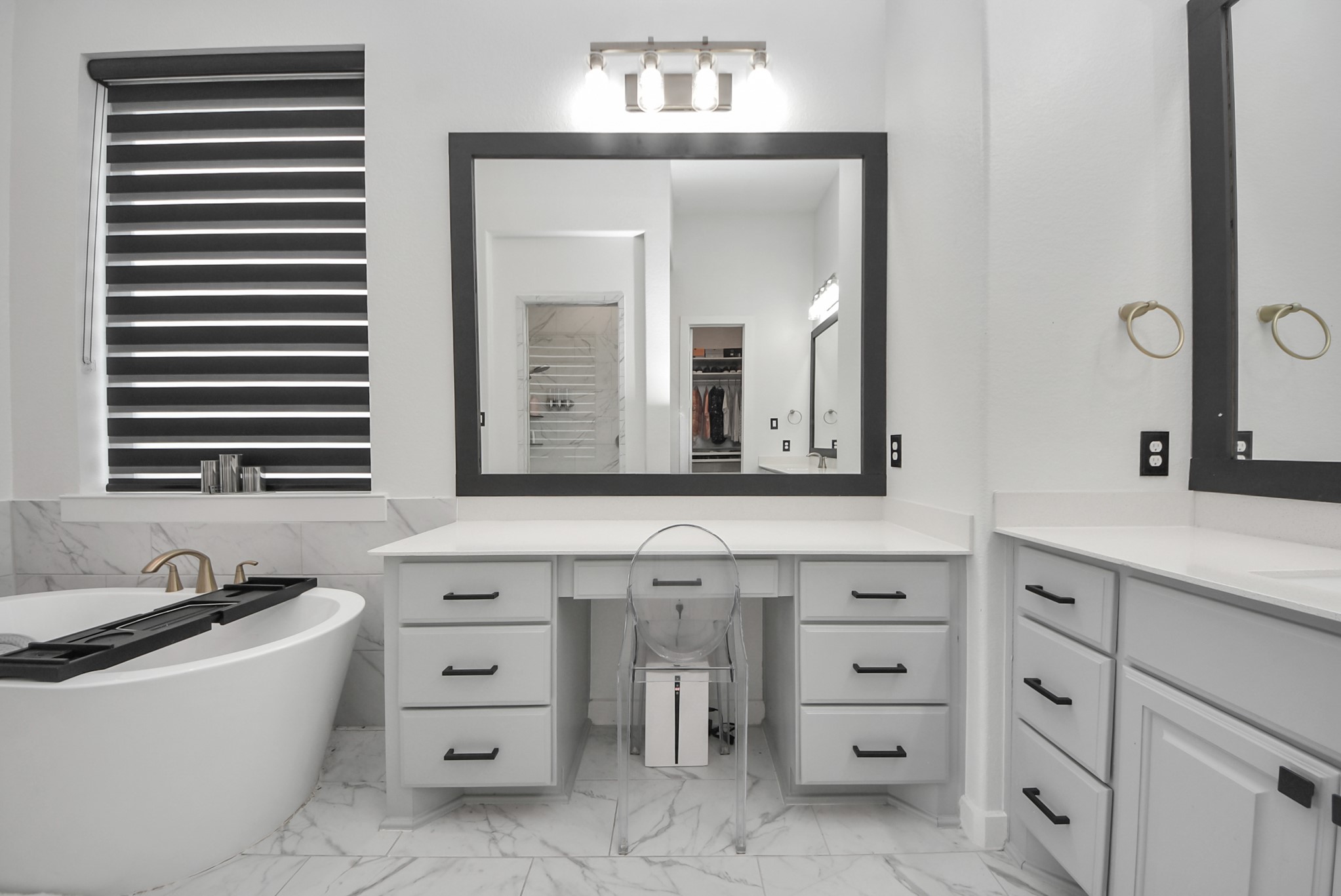 Beautiful primary bath with a soaking tub, separate vanities, and modern finishes.