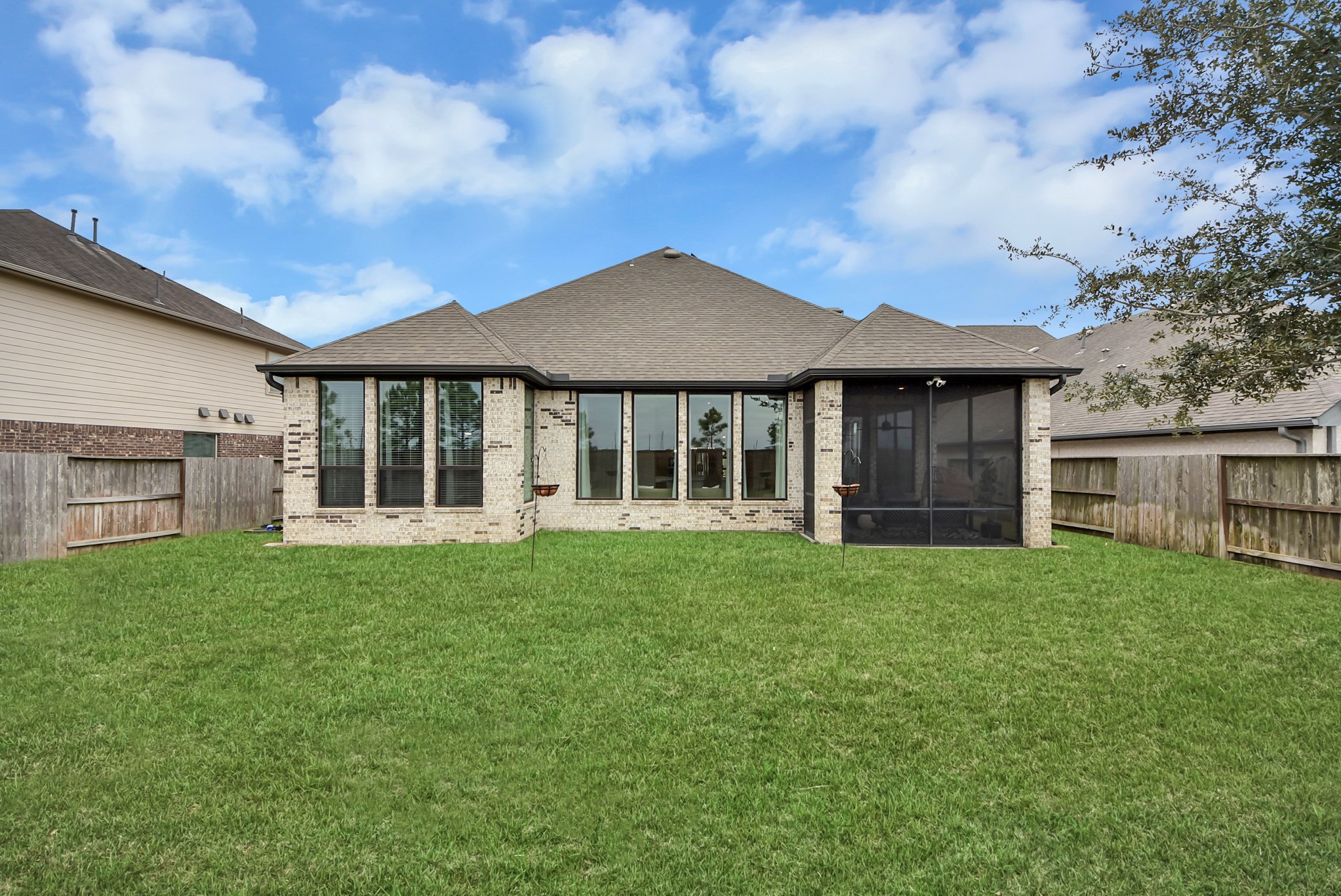 Spacious backyard featuring a well-maintained lawn and covered patio.