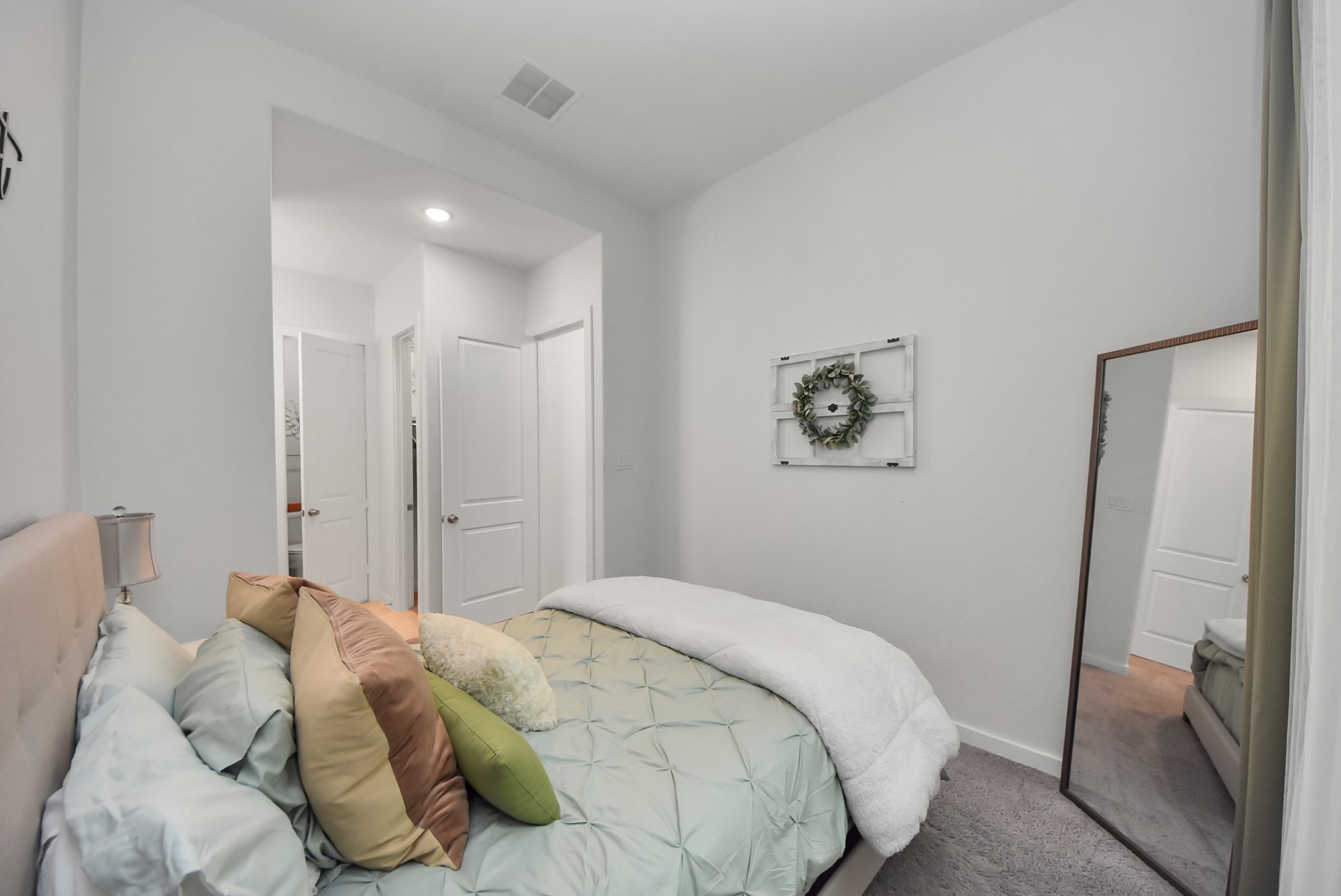 Comfortable bedroom featuring soft neutral tones and natural light.
