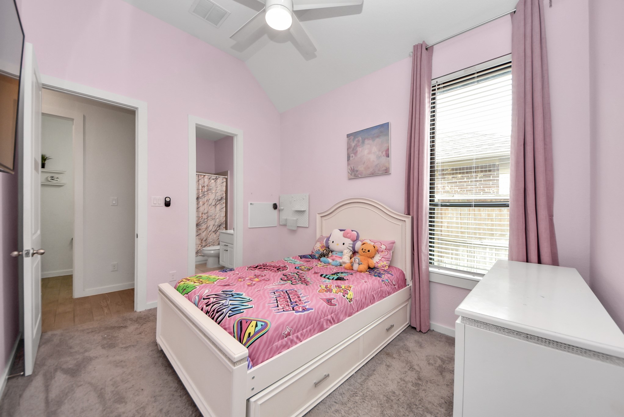 Bright and cheerful bedroom with colorful dcor and abundant natural lighting.