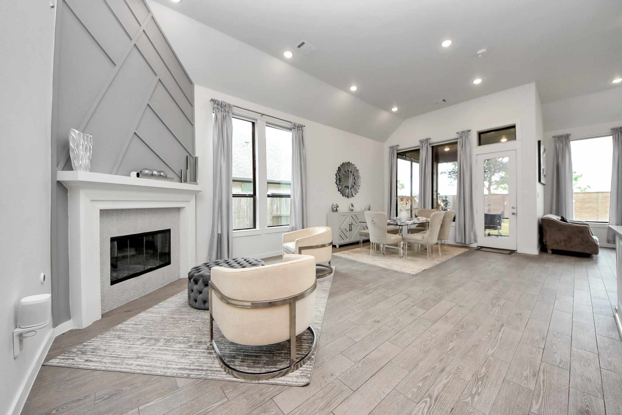 Spacious living area featuring a cozy fireplace and an open-concept layout.