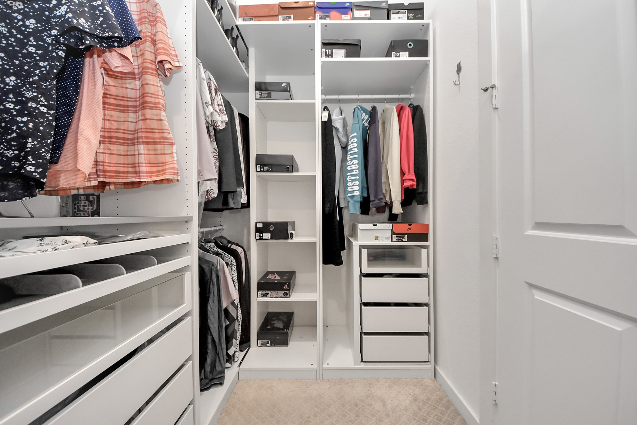 Spacious walk-in closet featuring built-in shelving and organized storage.