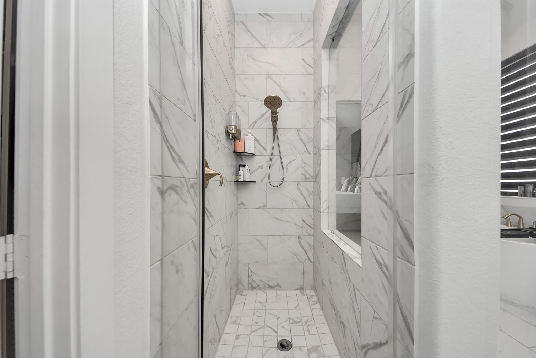 Stylish walk-in shower featuring attractive tilework and glass enclosure.