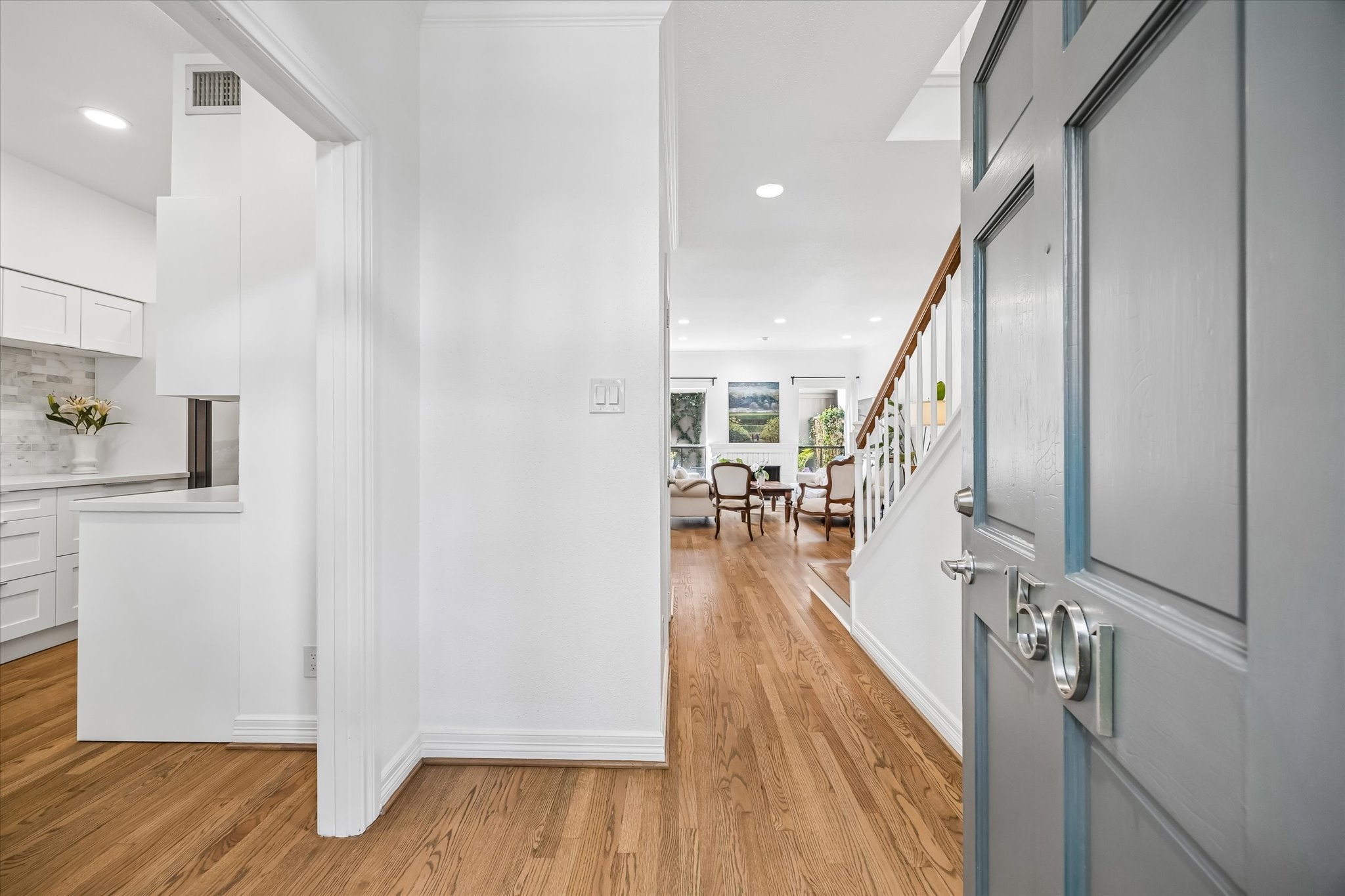 Step into an inviting home with a bright, open layout featuring refinished original oak hardwood floors, downstairs and on the staircase.
