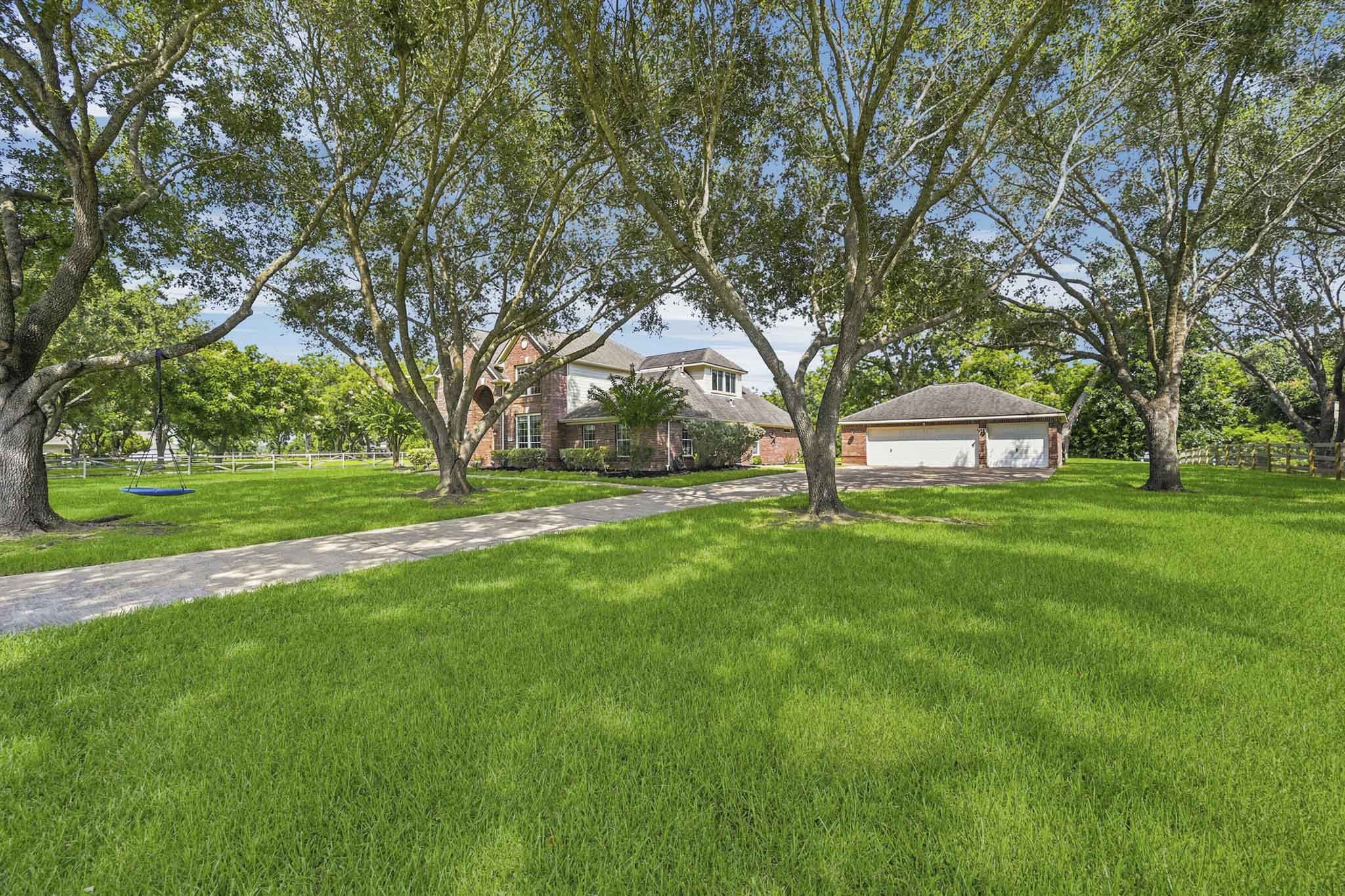 Oversized 3-car garage featuring a dedicated workshop area. Oversized 3-car garage featuring a dedicated workshop area.