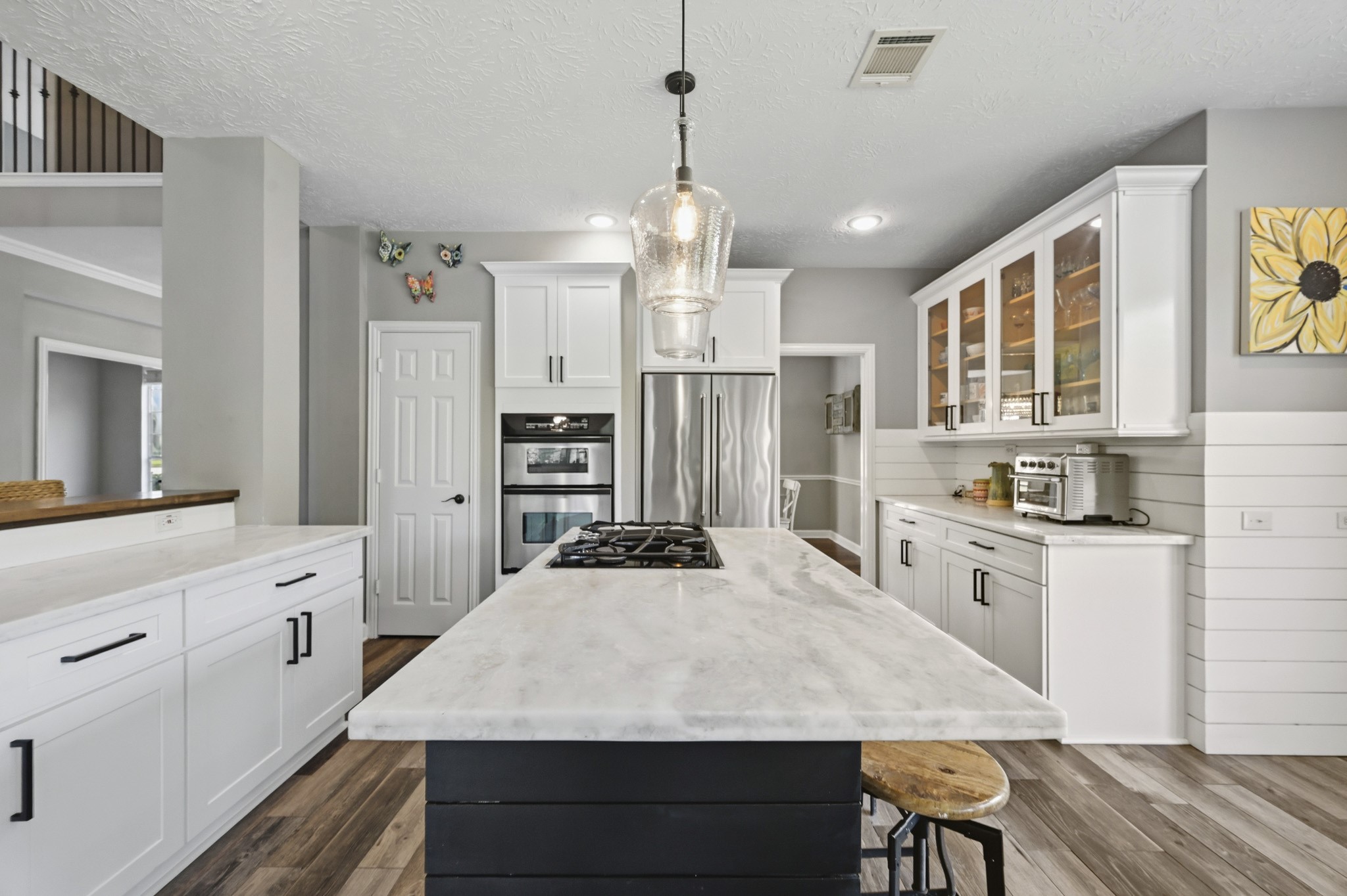 Well-appointed kitchen featuring marble countertops, extensive workspace, and soft-close cabinetry.