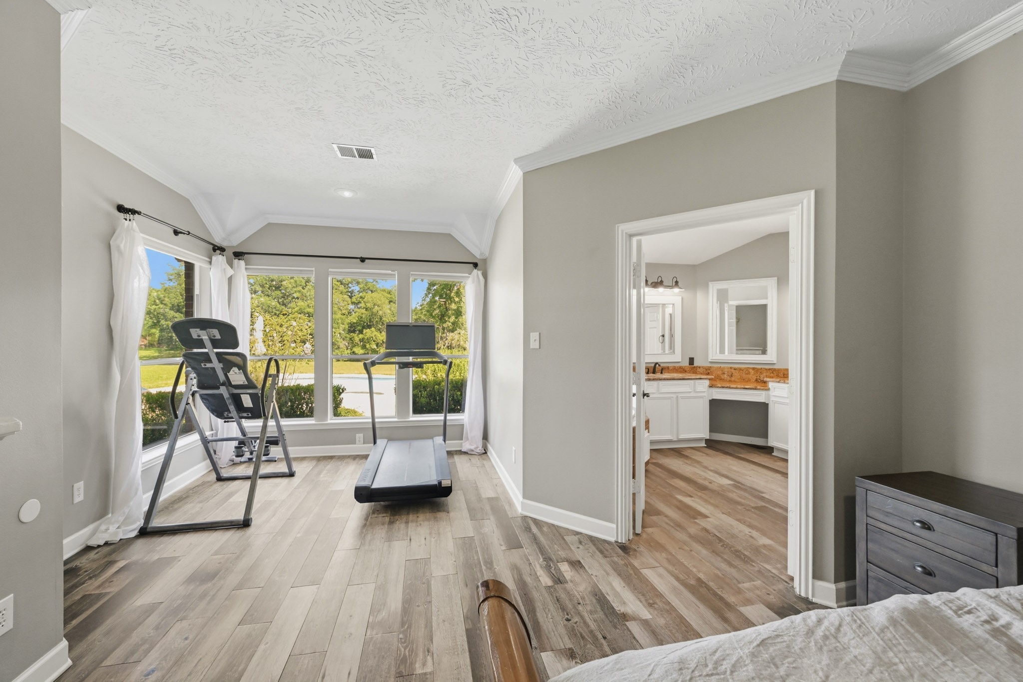 Primary suite overlooking the heated pool, spa, and private backyard retreat.
