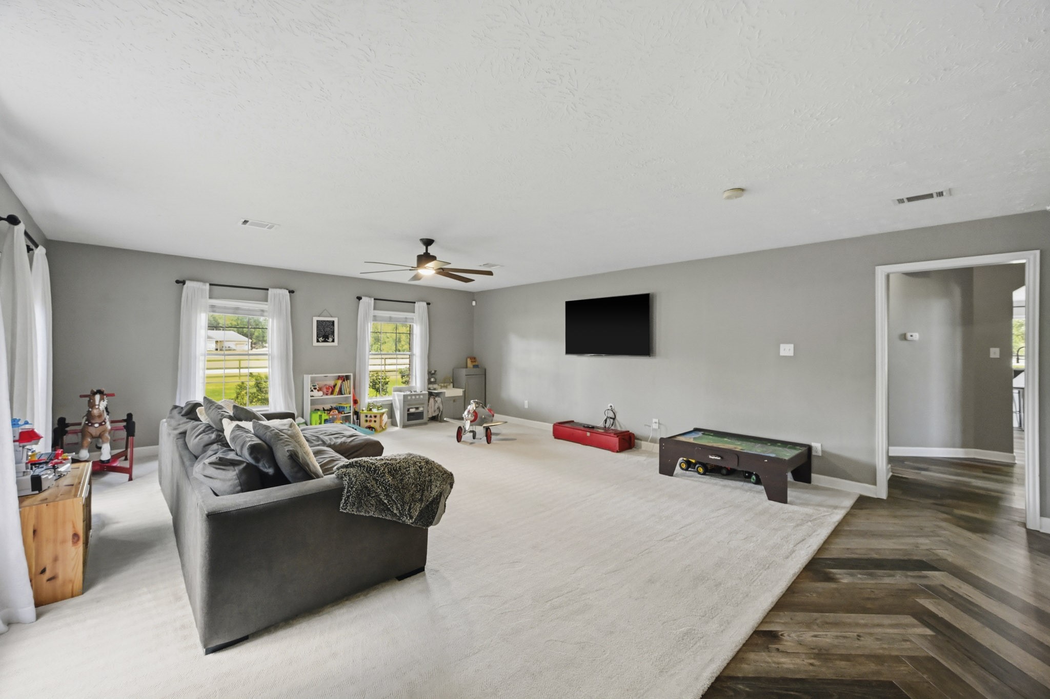Game room featuring entertainment space, wine refrigerator, and dry bar area.