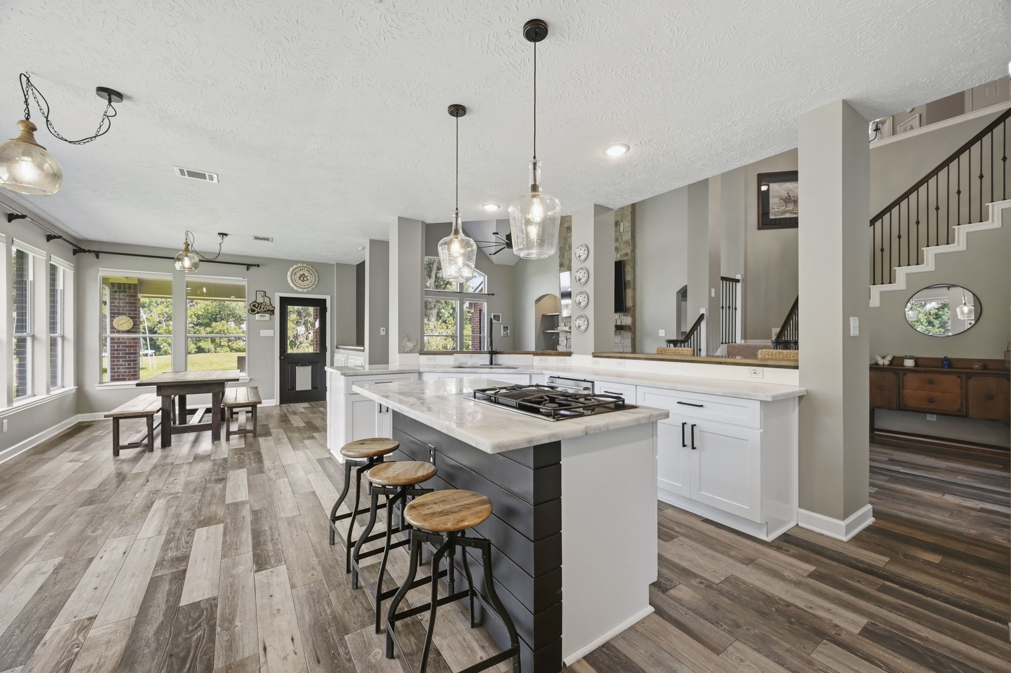 Open view of the kitchen, breakfast area, and family room.