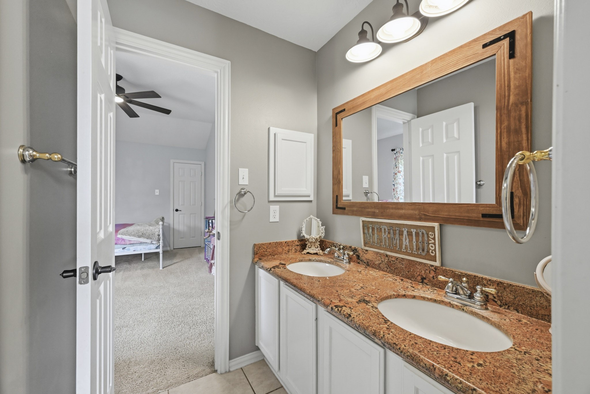 Secondary bath featuring dual vanities and ample counter space.