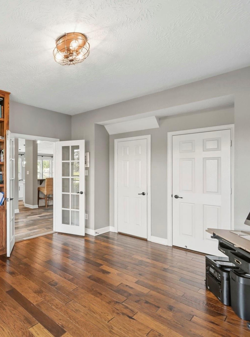 Private study with built-in bookcases and closet, easily serving as a secondary downstairs bedroom.