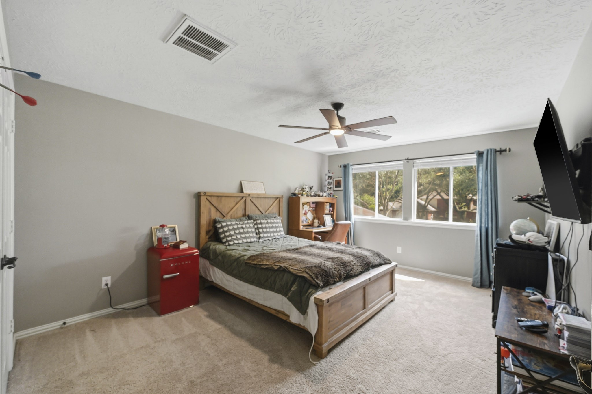 Oversized upstairs bedroom that could serve as a second primary suite, featuring expansive treetop views.