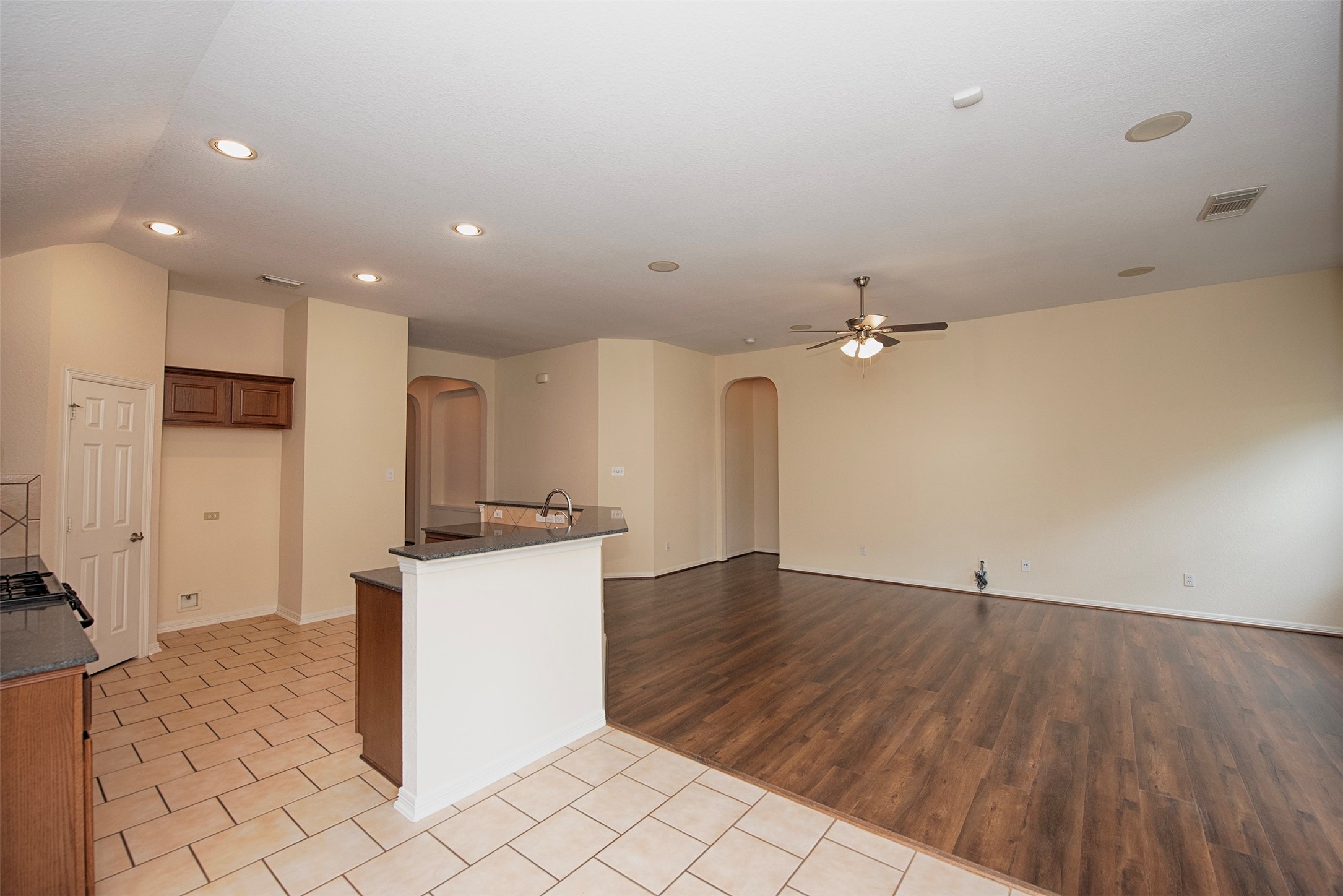 A view from the dining area open to both the kitchen but the family room as well.