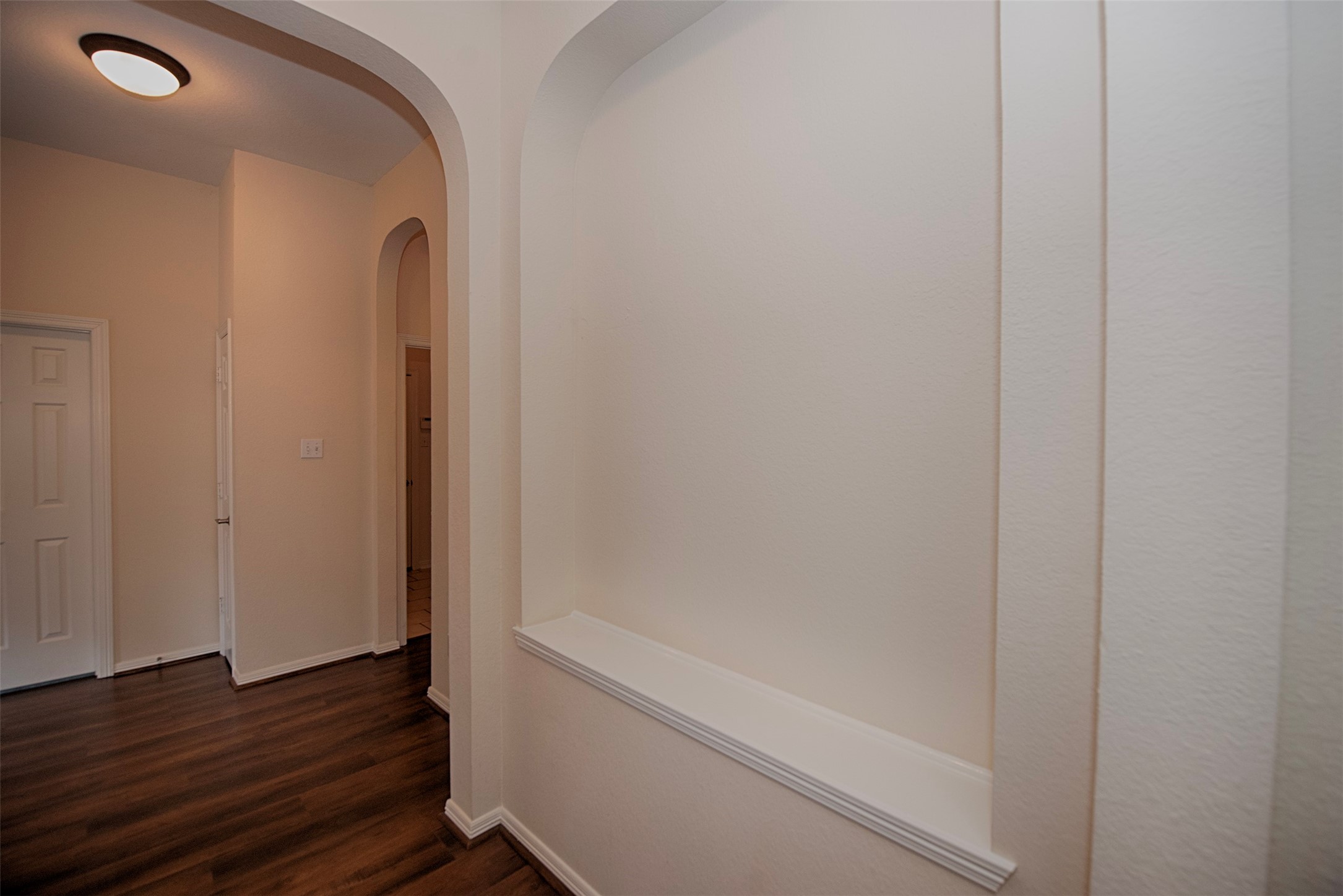 On the opposing side of the dining room is a large art niche. Perfect for showcasing a painting or maybe your family photos.