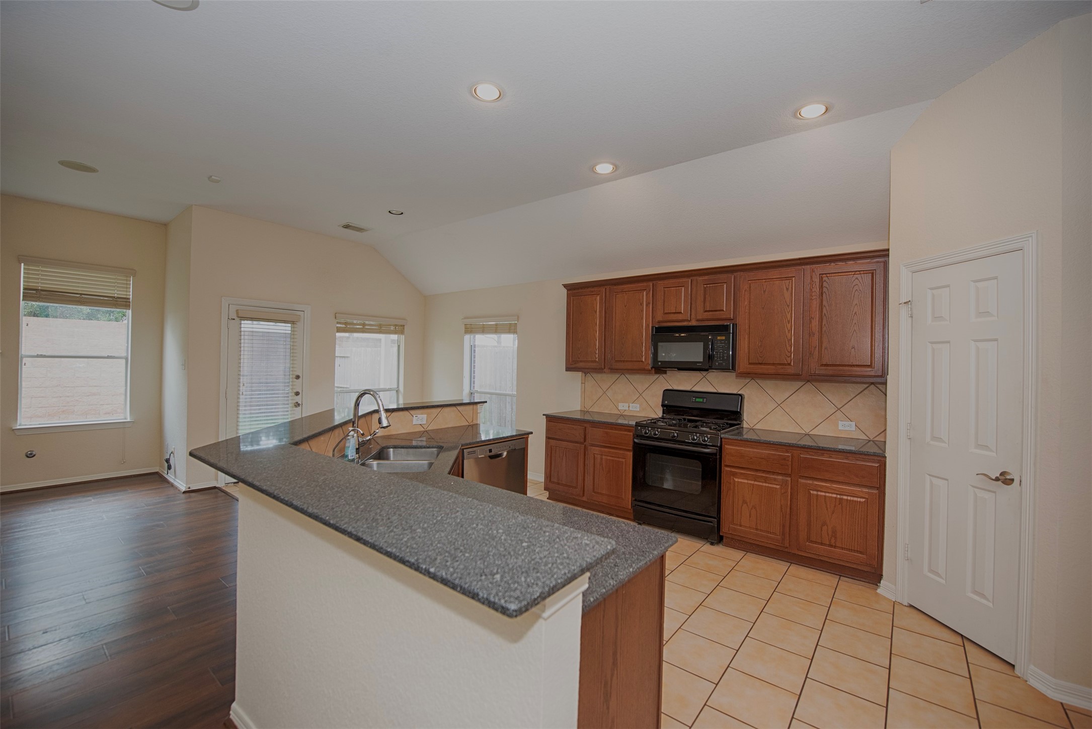 Entry to the beautiful kitchen with large island and granite counters.