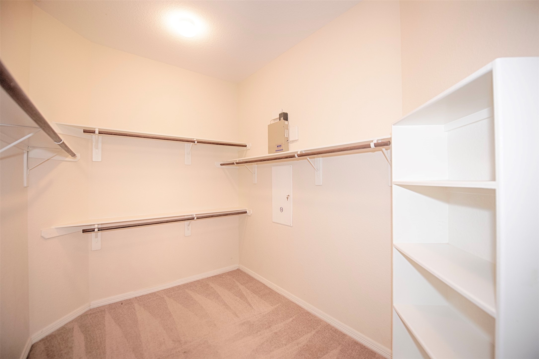 Huge walk in closet with built in shelving. Perfect for your shoes or hand bags.