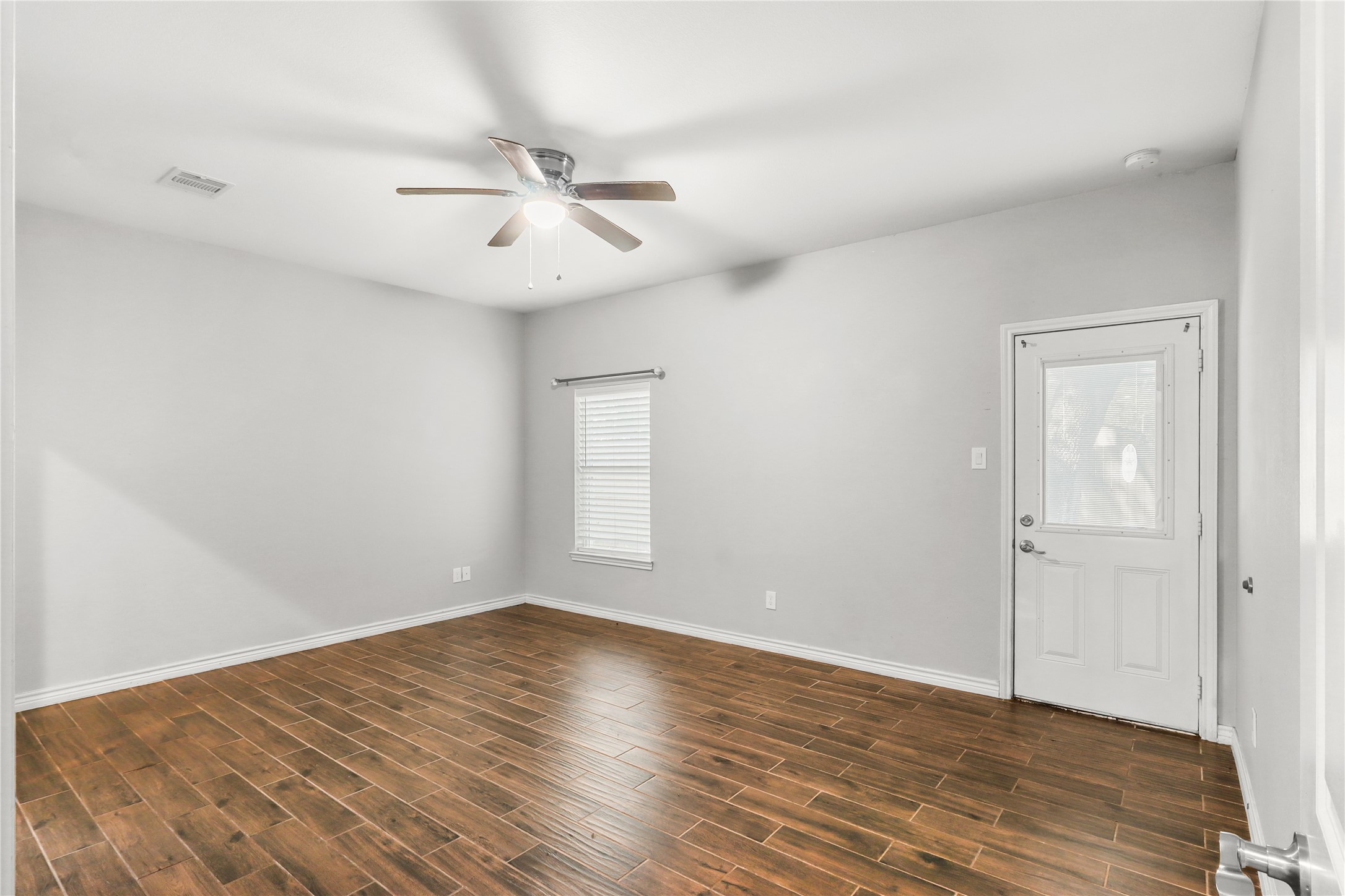 This is a Oversized master bedroom with backyard access.
