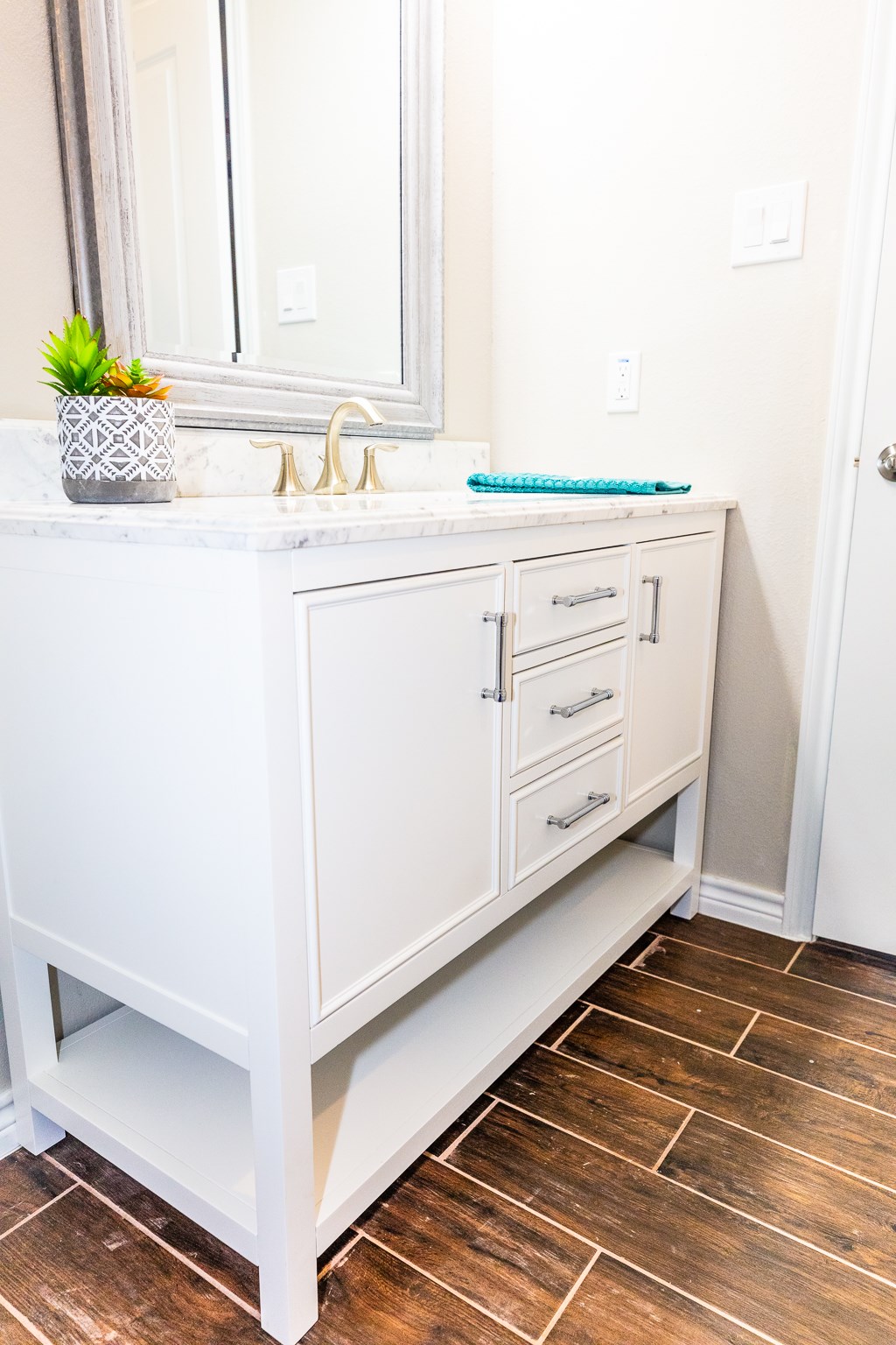 Soft close designer vanity with marble counter top, square sink and Moen fixtures