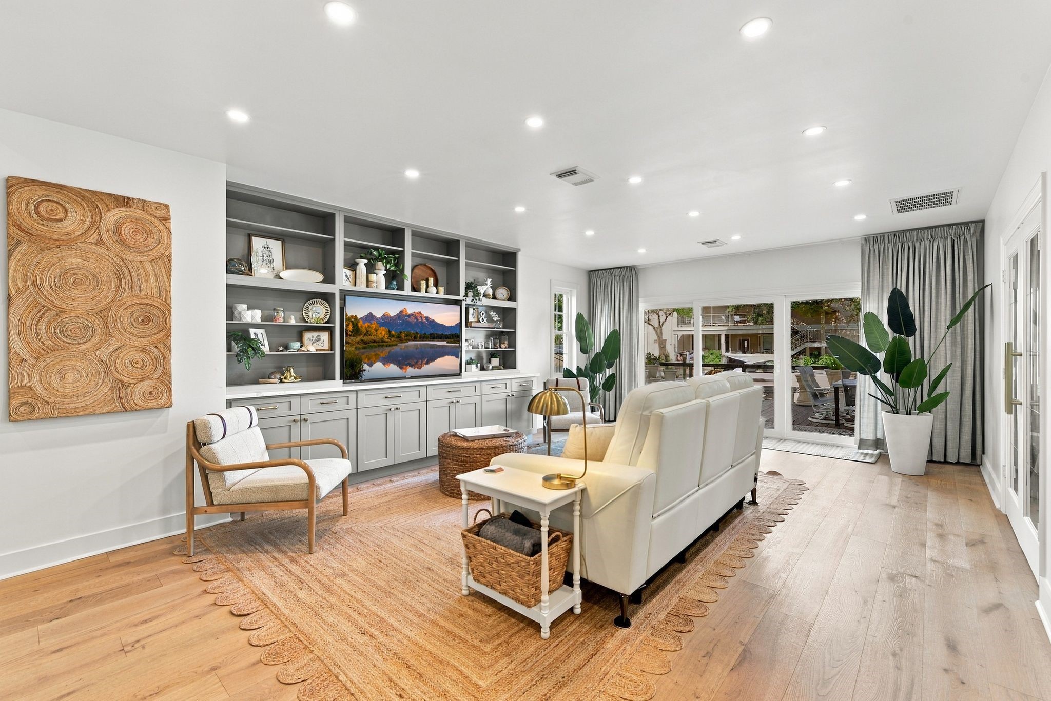 The Living room has nice built ins and has a wall of windows with a sliding glass door which open to the waterway.