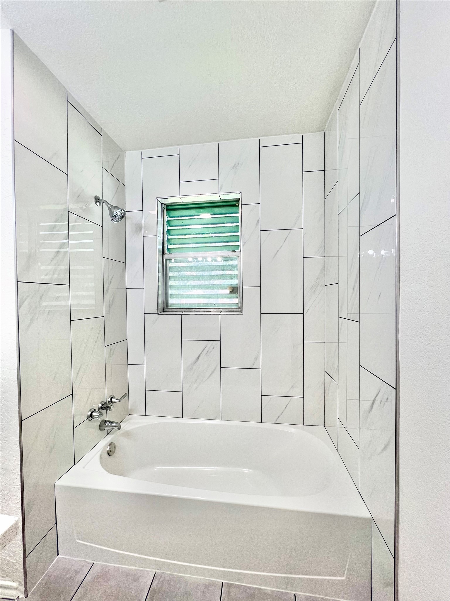 Floor to ceiling tile in the newly remodeled Bathroom