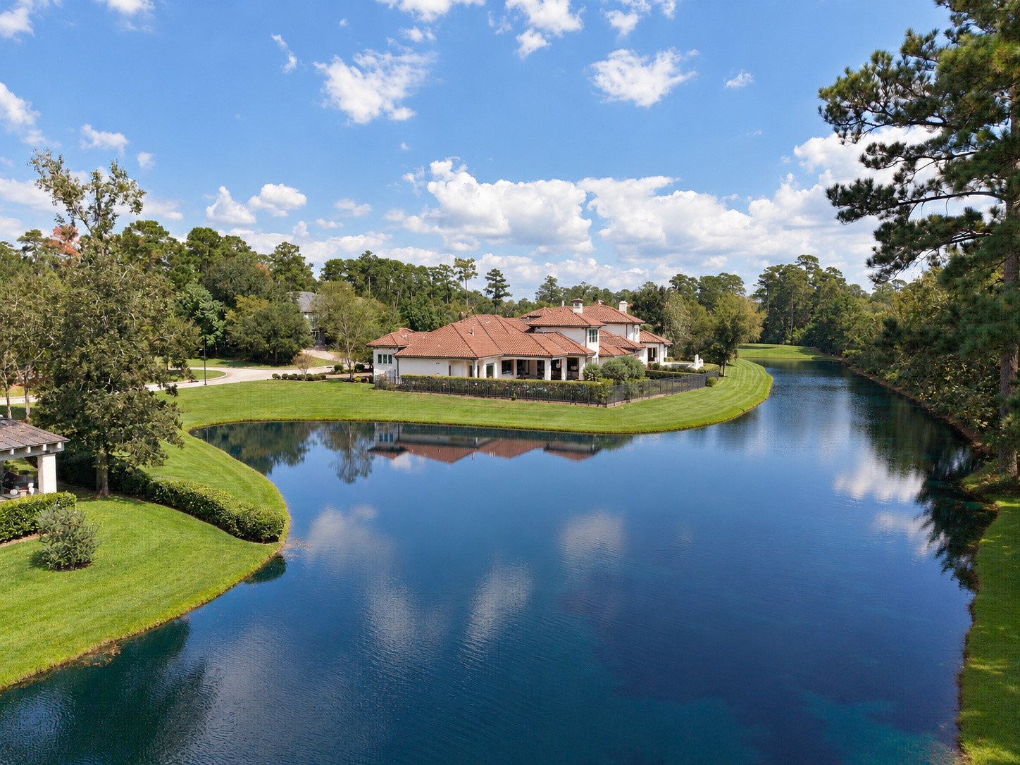 Spectacular aerial view showcasing the estate's unique peninsula setting, with sparkling water on both sides and breathtaking views in every direction