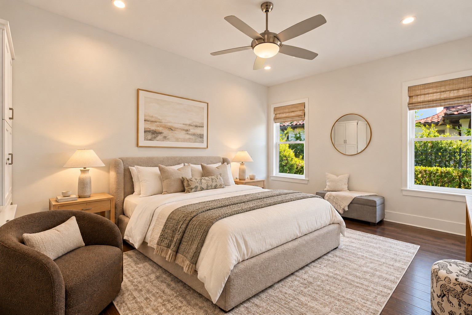 Second primary suite on the first floor, featuring serene lake views, a private en-suite bath, and a spacious walk-in closet.