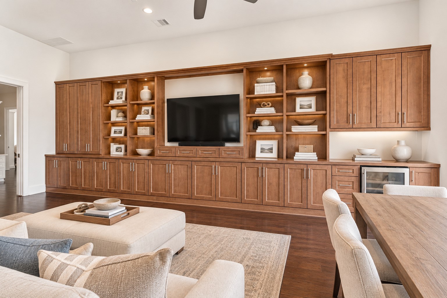 Game room featuring beautiful hardwood floors, custom built-ins, and an abundance of natural light. A comfortable and inviting space perfect for entertaining, relaxing, or enjoying time with family and friends.