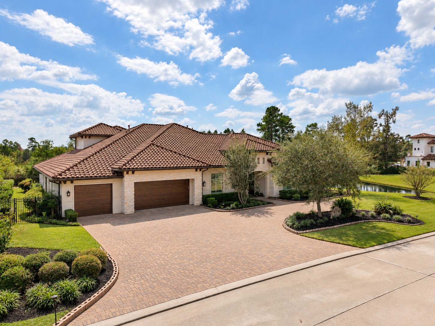 Spacious four-car garage complemented by an expansive paver driveway, offering ample parking and an impressive entrance to this luxury estate.