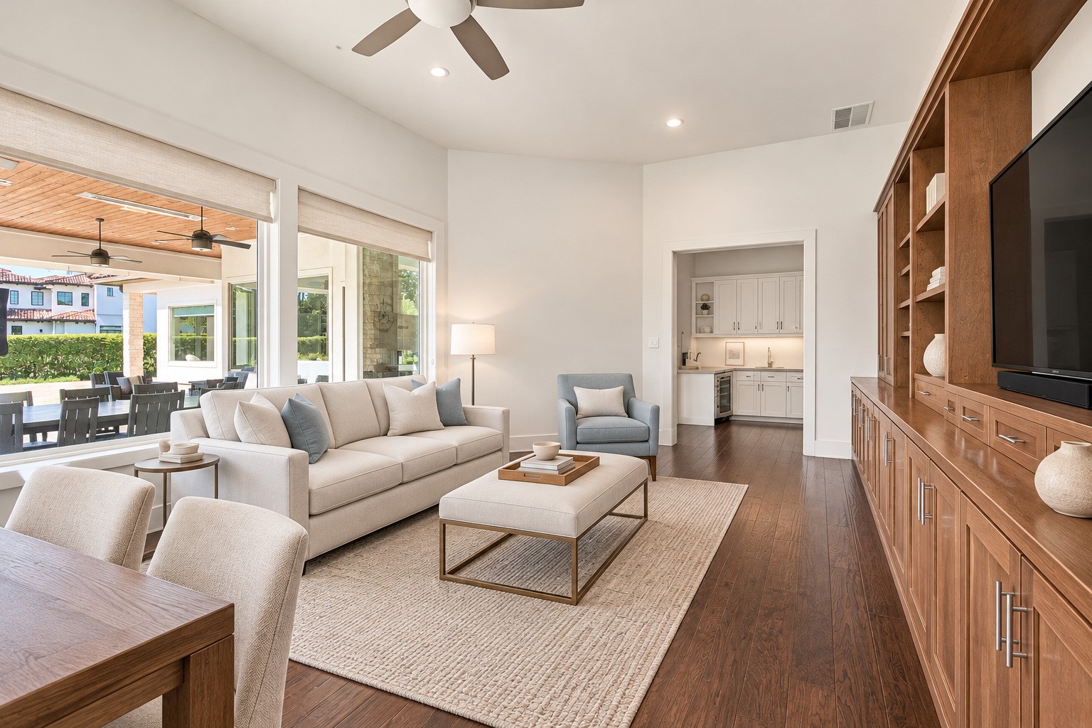 Game room featuring beautiful hardwood floors, custom built-ins, and an abundance of natural light. A comfortable and inviting space perfect for entertaining, relaxing, or enjoying time with family and friends.