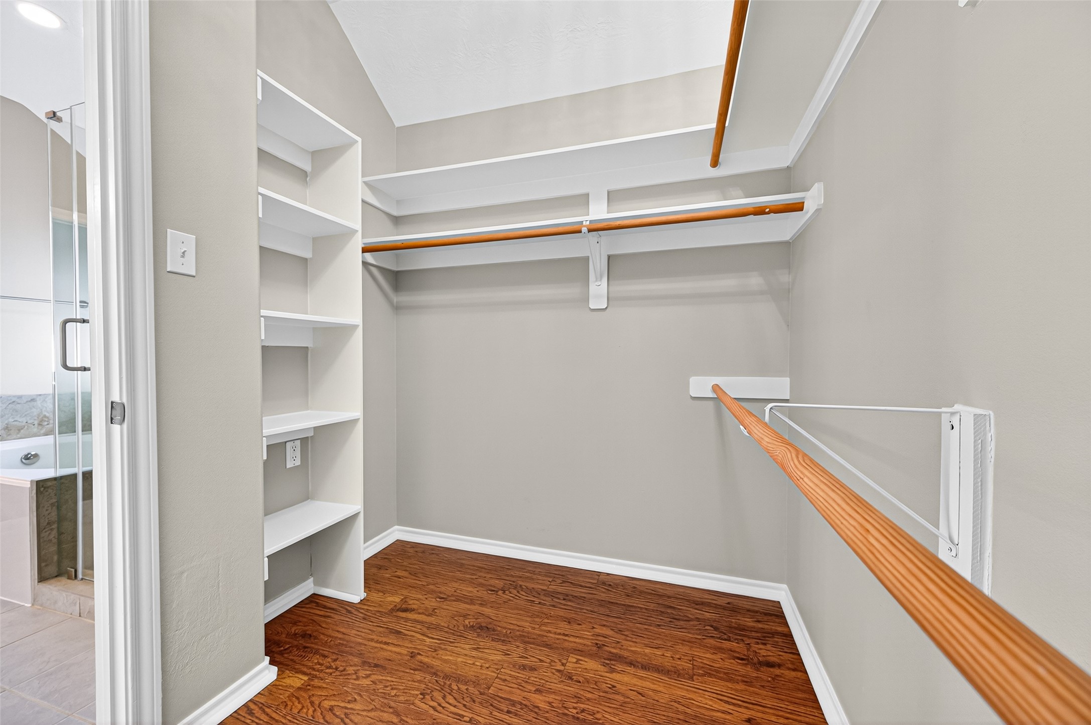 Large walk in closet with built in shelving and tons of storage