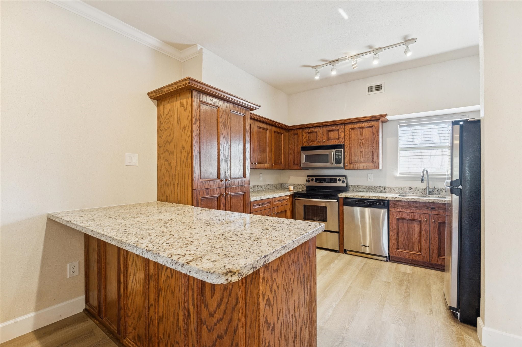 Closer view of kitchen with granite counters and stainless appliances. Closer view of kitchen with granite counters and stainless appliances.