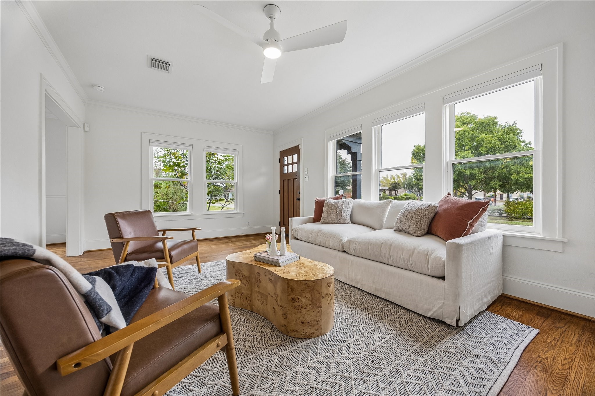 The living room features original hardwood floors and custom built-ins