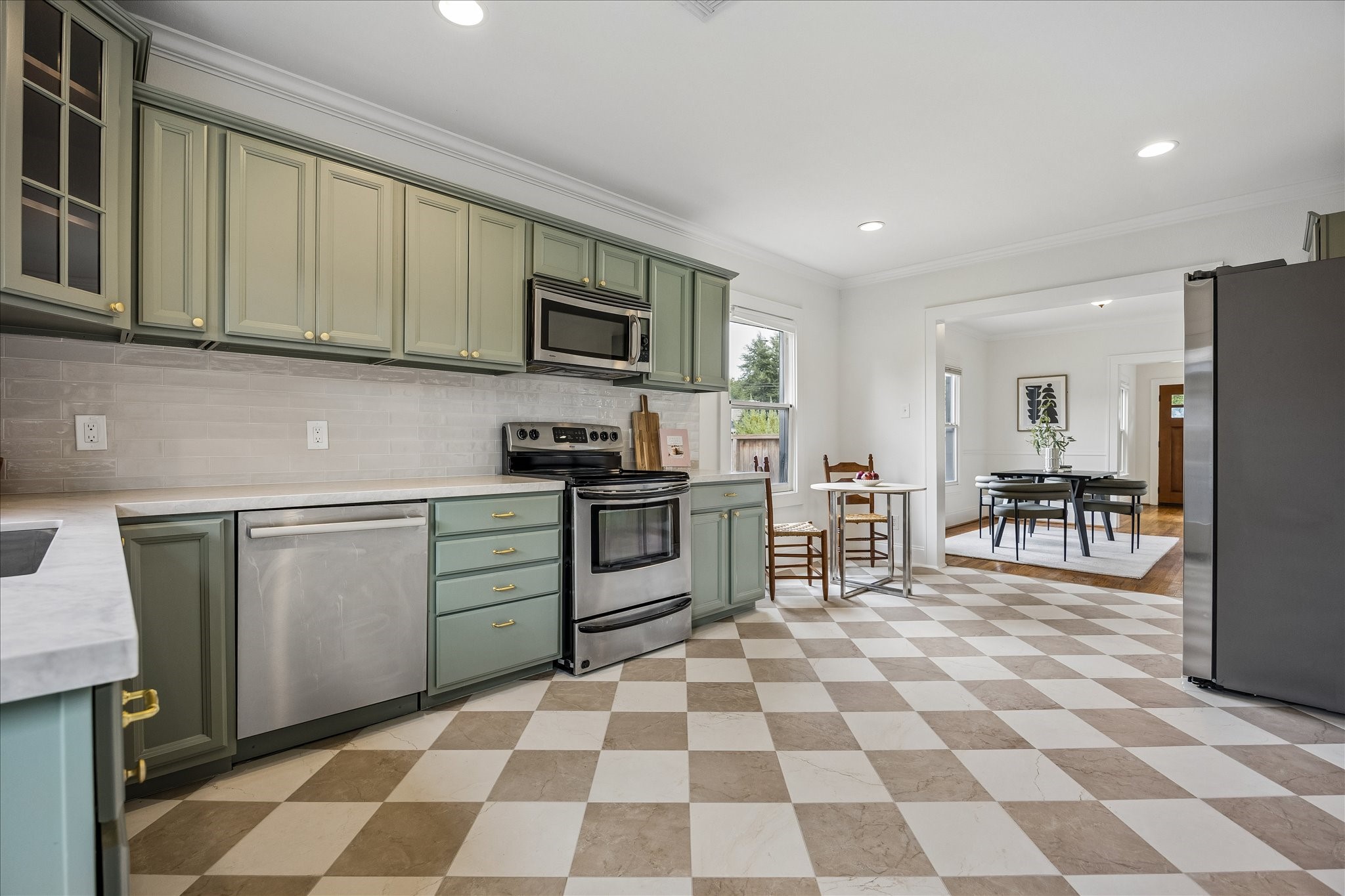 The kitchen boasts quartz counters and subway tile backsplash