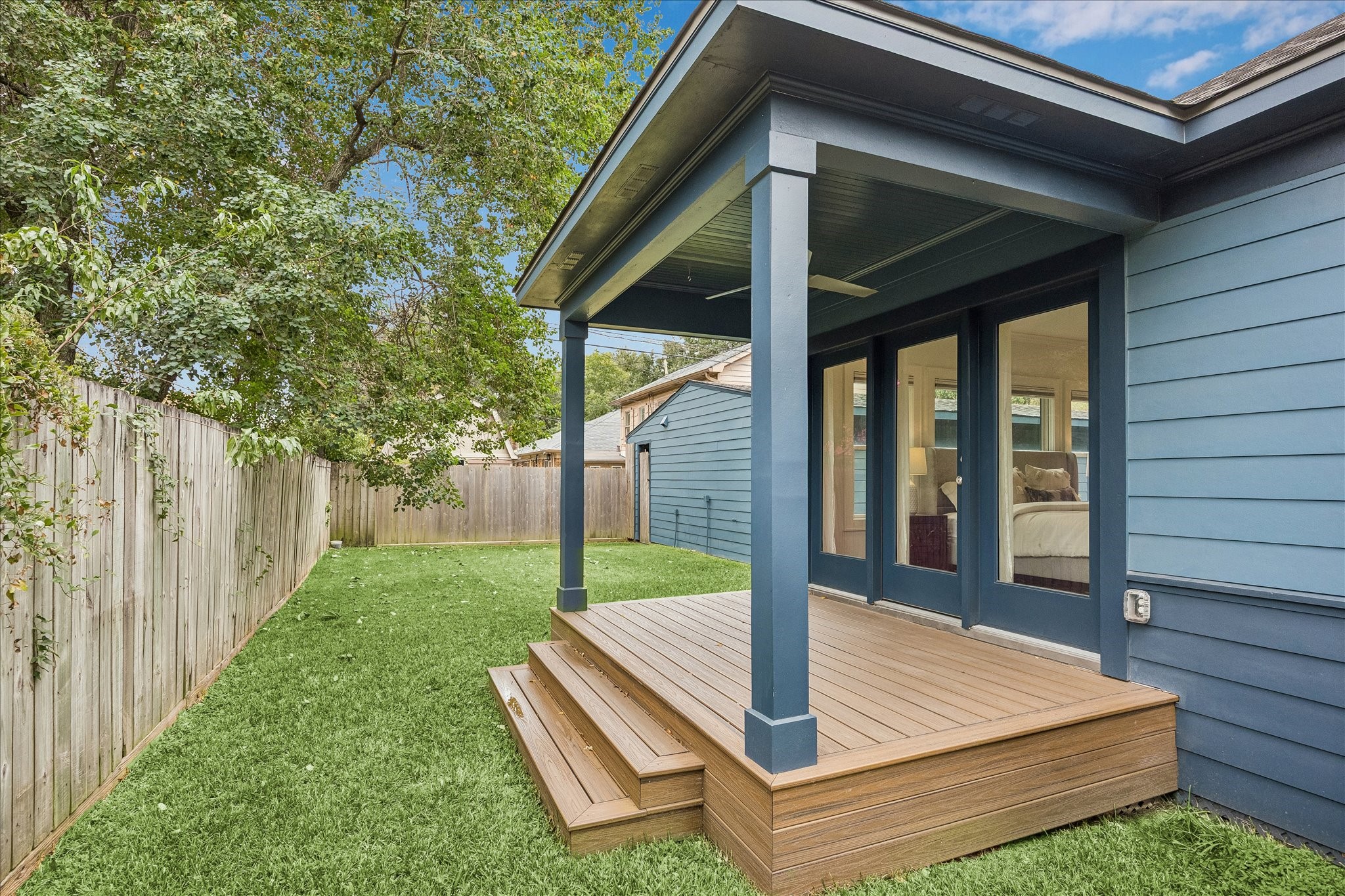 View from the covered patio just off the primary suite overlooking the tranquil backyard