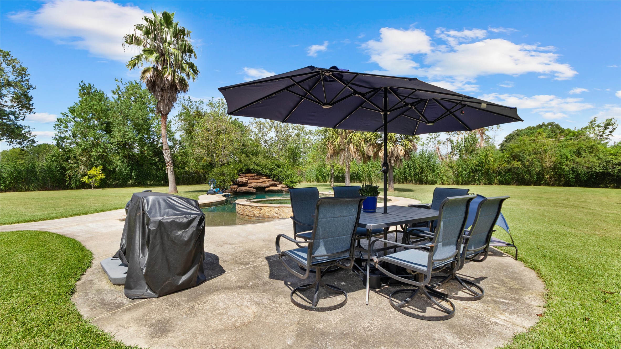 A great spot to set up your poolside seating and enjoy the backyard.
