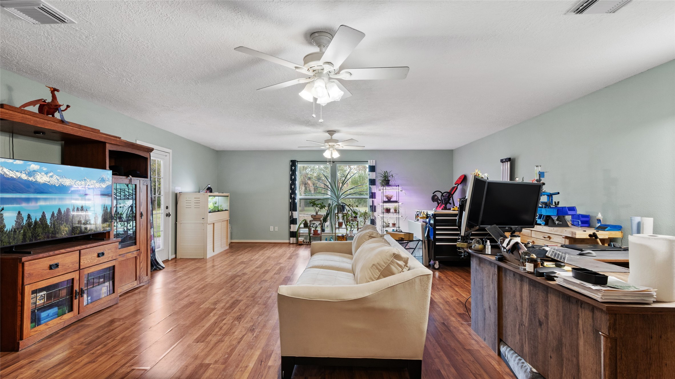 Plenty of room to move comfortably in this large second primary bedroom, with wheelchair accessibility and a separate backyard door.