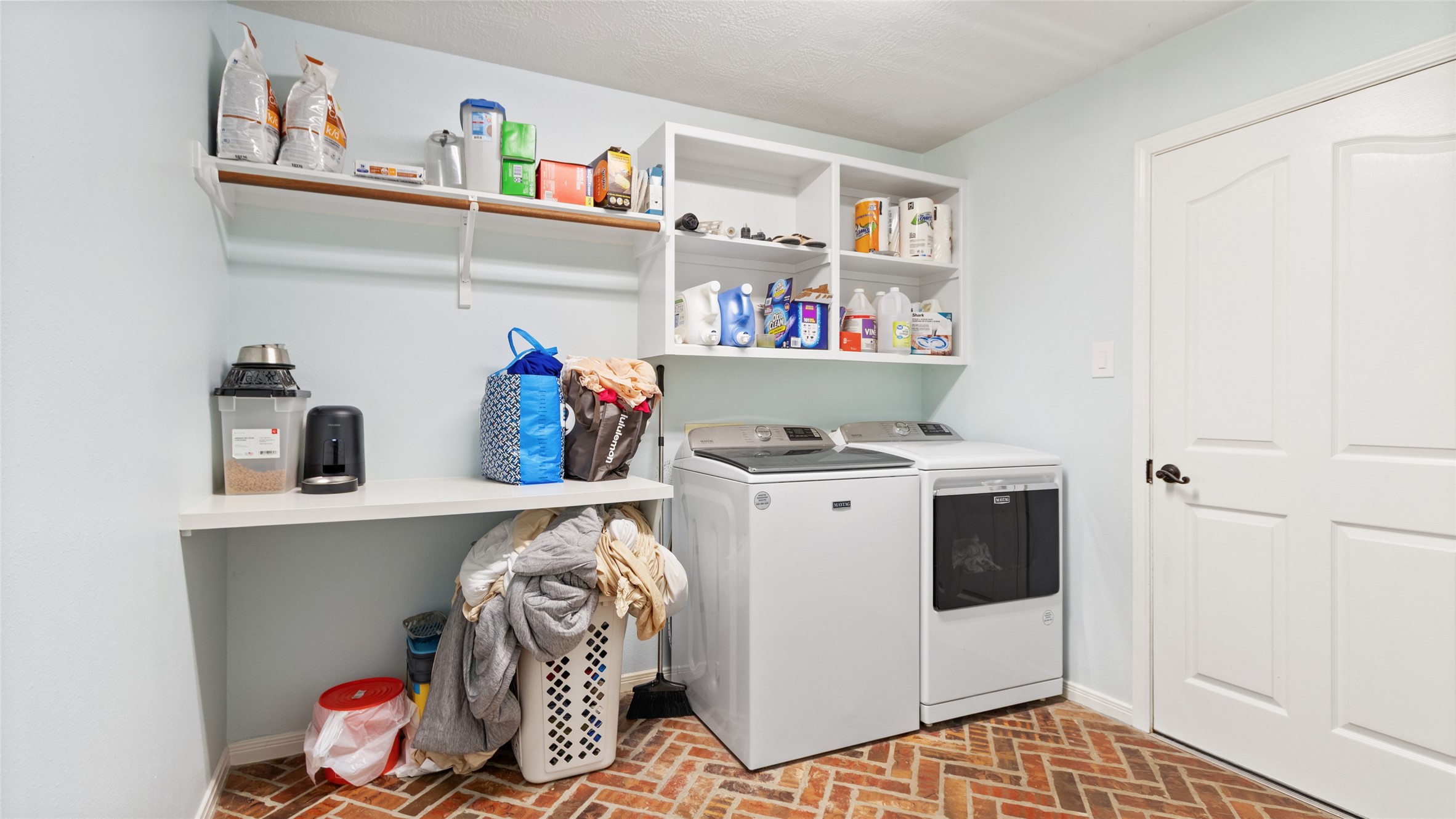 A dedicated laundry room keeps everyday chores tucked away and organized.