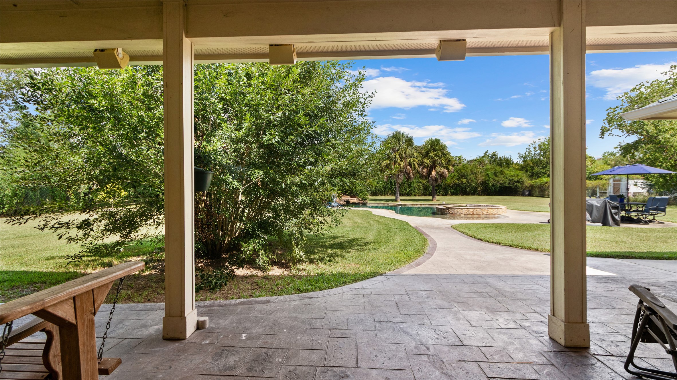 Step outside to the covered patio, a great spot to enjoy the backyard in a little more shade.