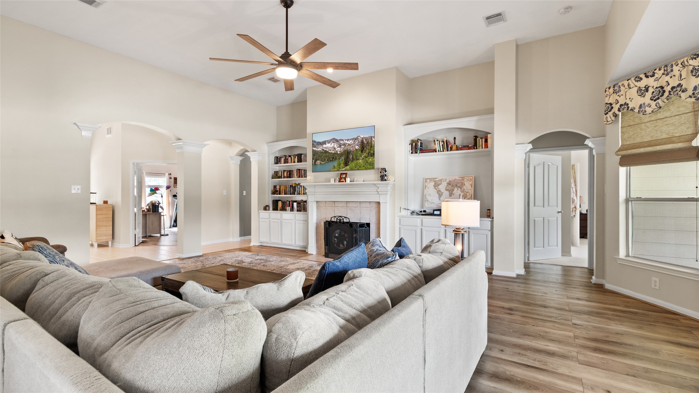 The wood burning fireplace creates a cozy focal point, framed by built in bookshelves on both sides for extra character and storage.