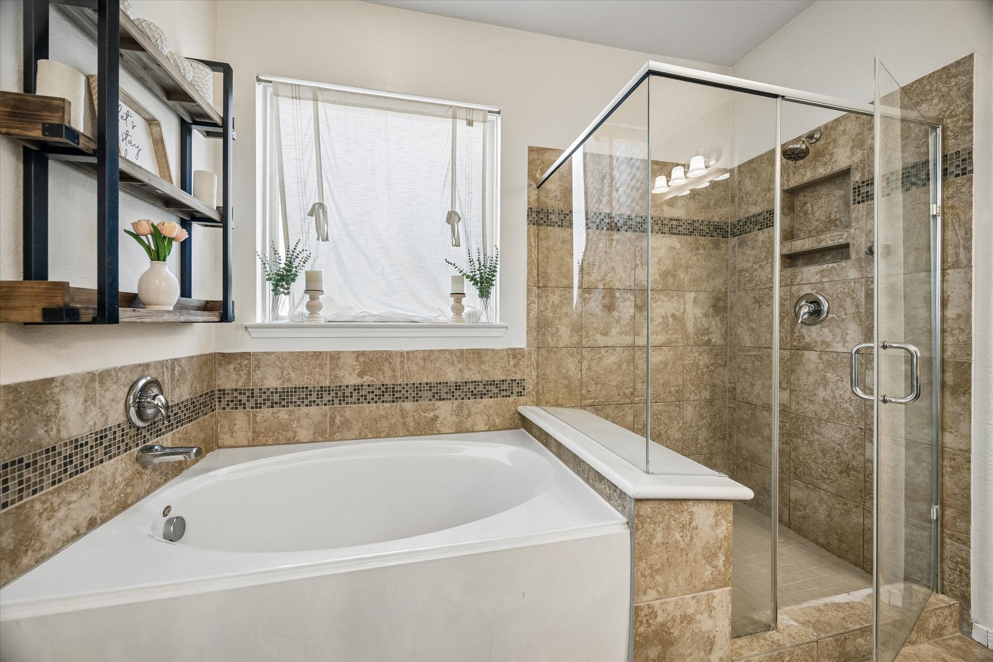 Separate shower and tub with beautiful tile.