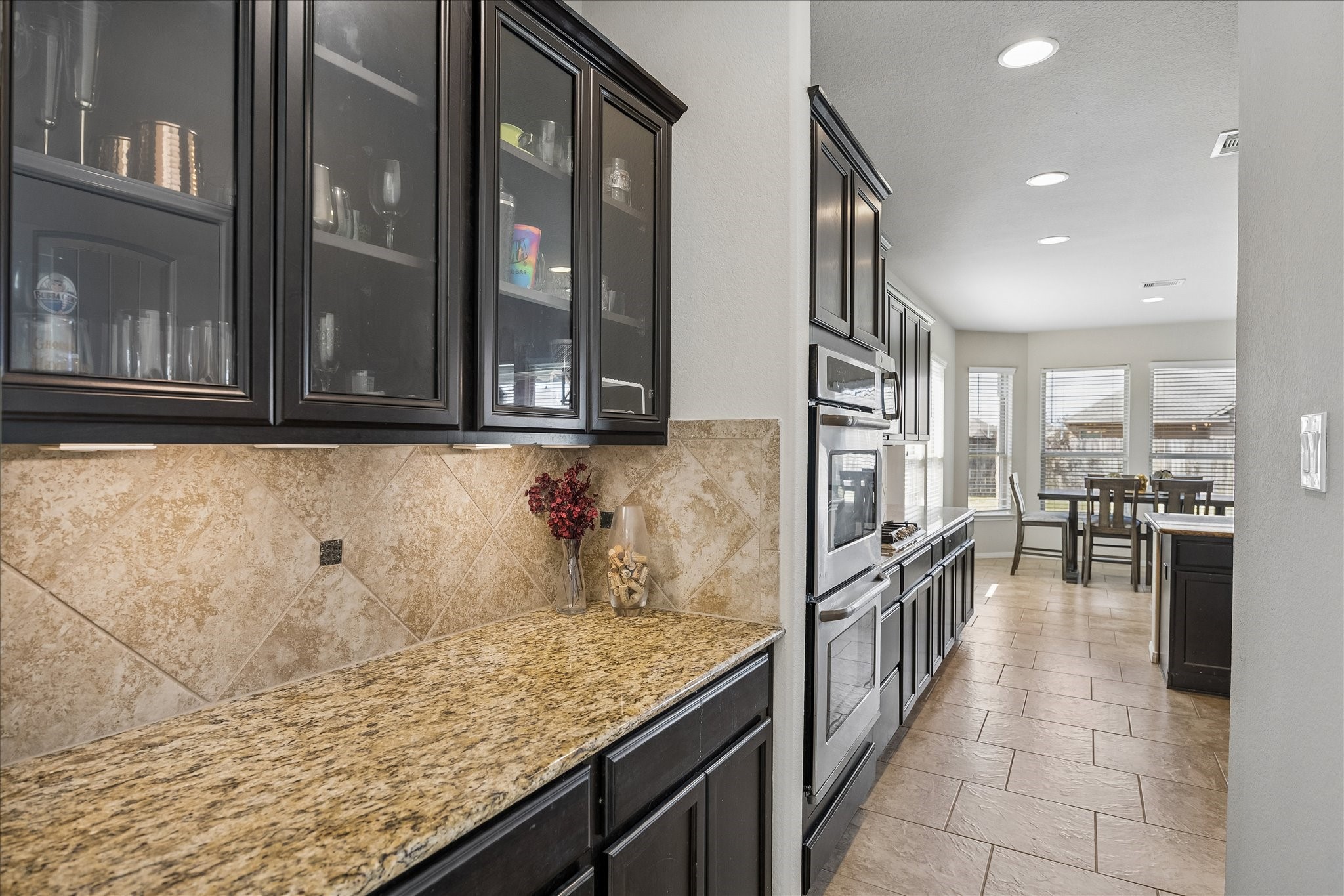 Butler's pantry that flows into the kitchen.  Perfect for a coffee bar with cabinets for extra storage.