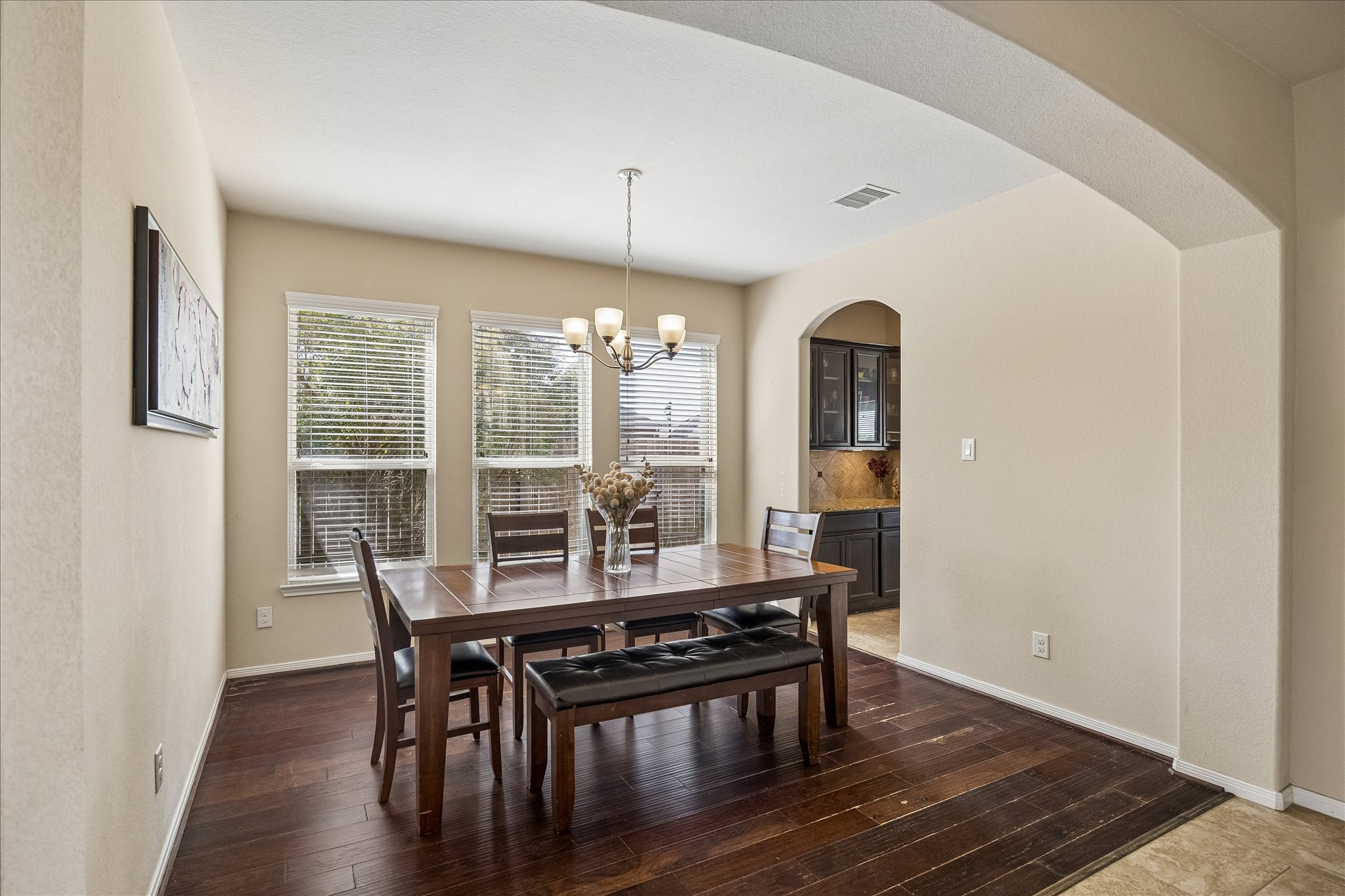 Formal dining room with a beautiful, arched ceiling and three large windows to let in the sunlight.