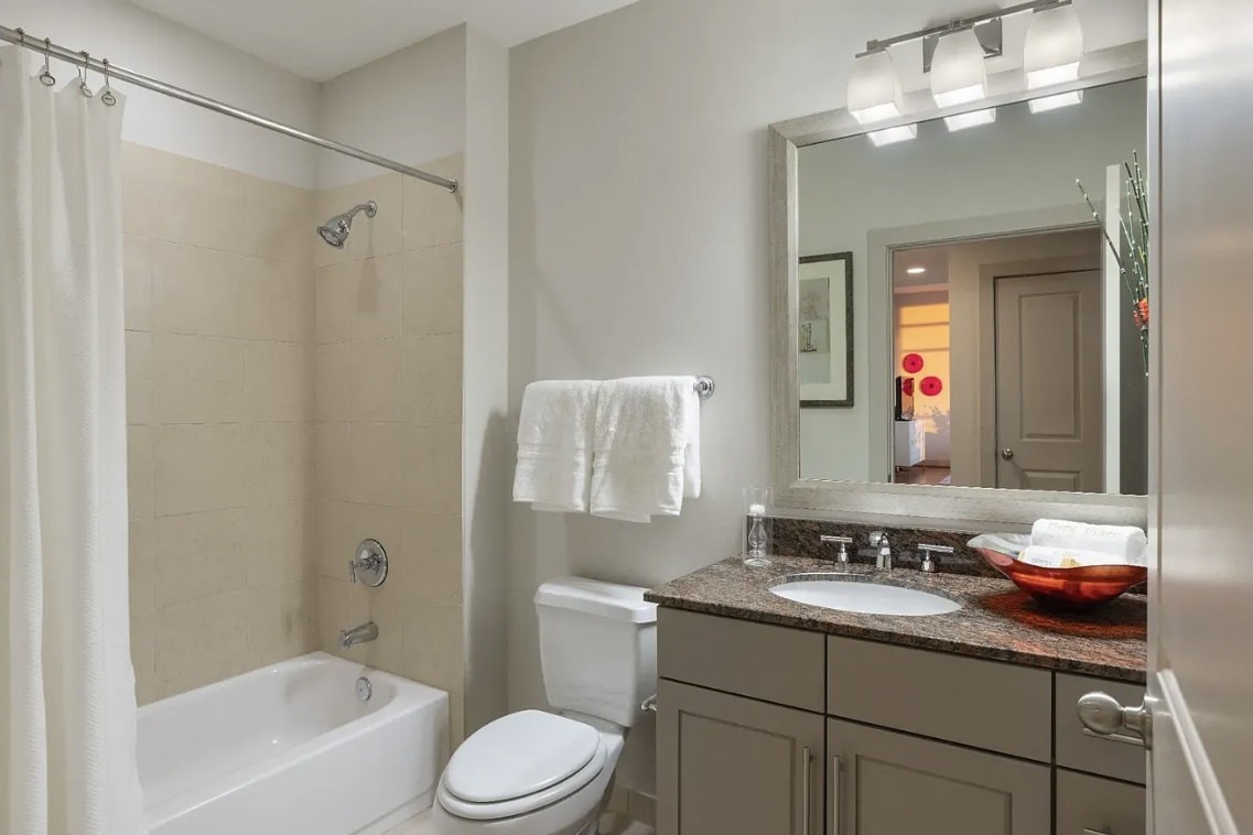 The secondary bathroom features granite countertops, stylish cabinetry and a full tub and shower combination. Thoughtfully designed for both comfort and functionality, it provides a welcoming space for family members and overnight guests.
